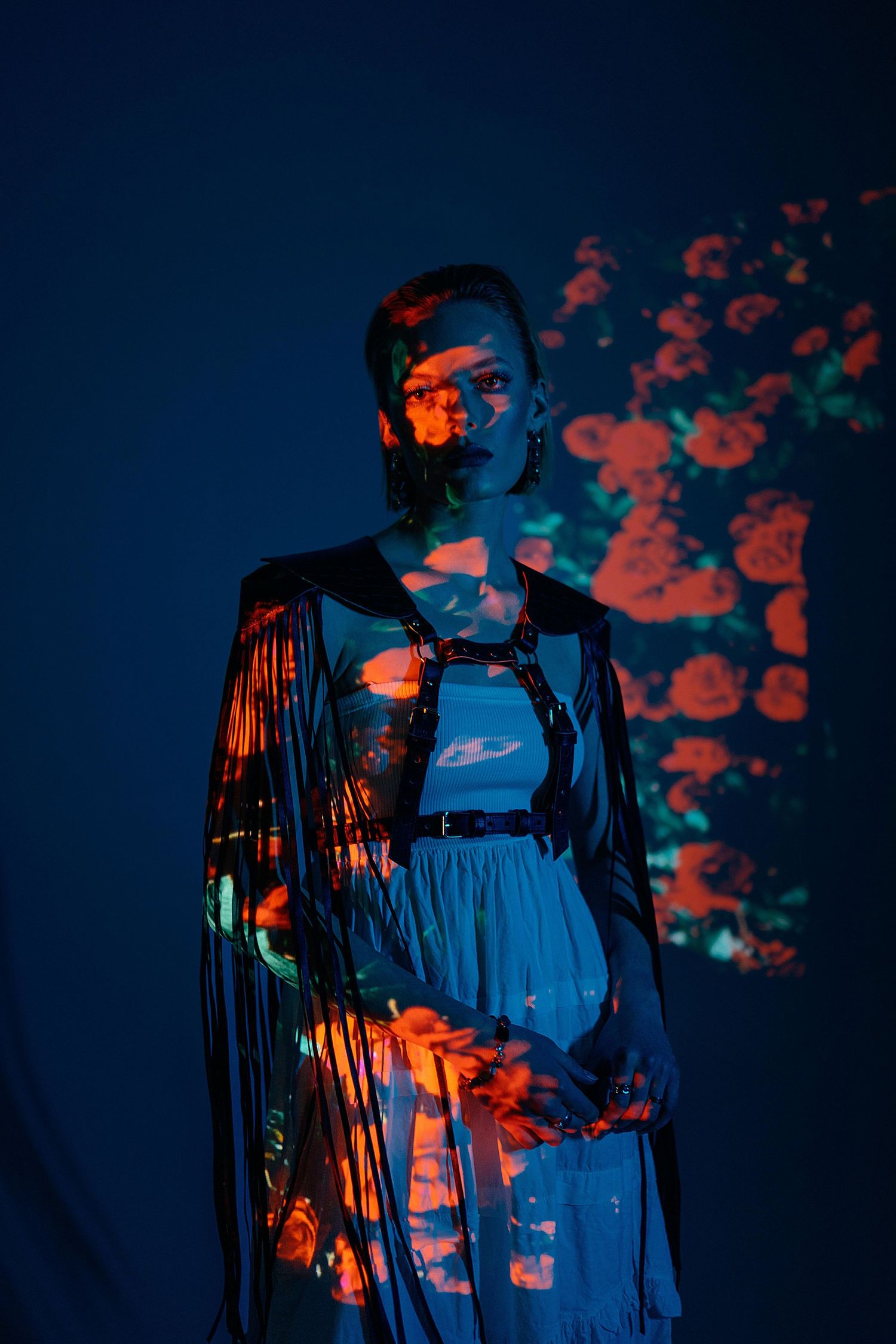 Silhouetted figures in blue and orange lighting create a dramatic atmospheric scene during a performance.