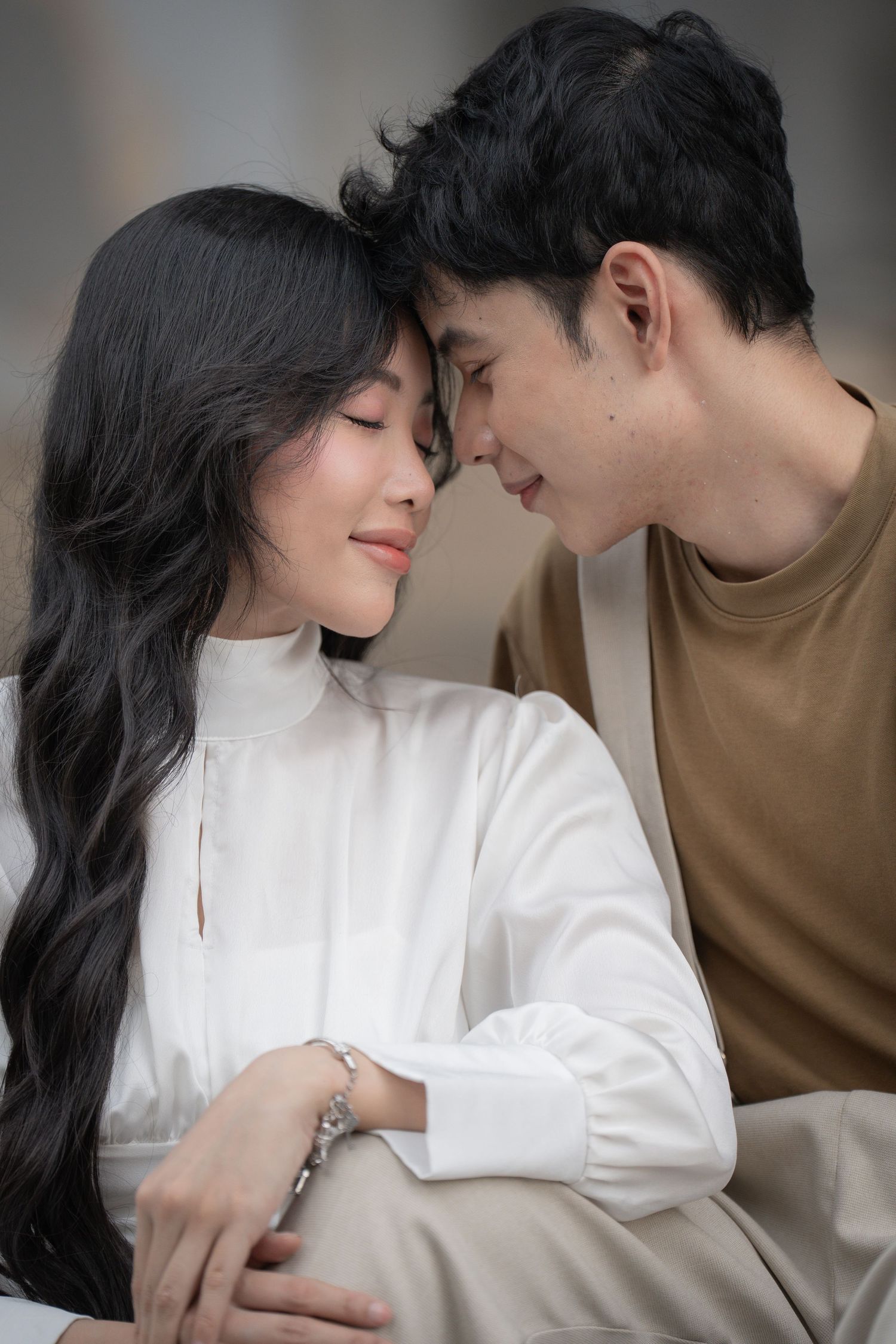 Intimate close-up shots of couple in brown and white attire sharing tender moments.