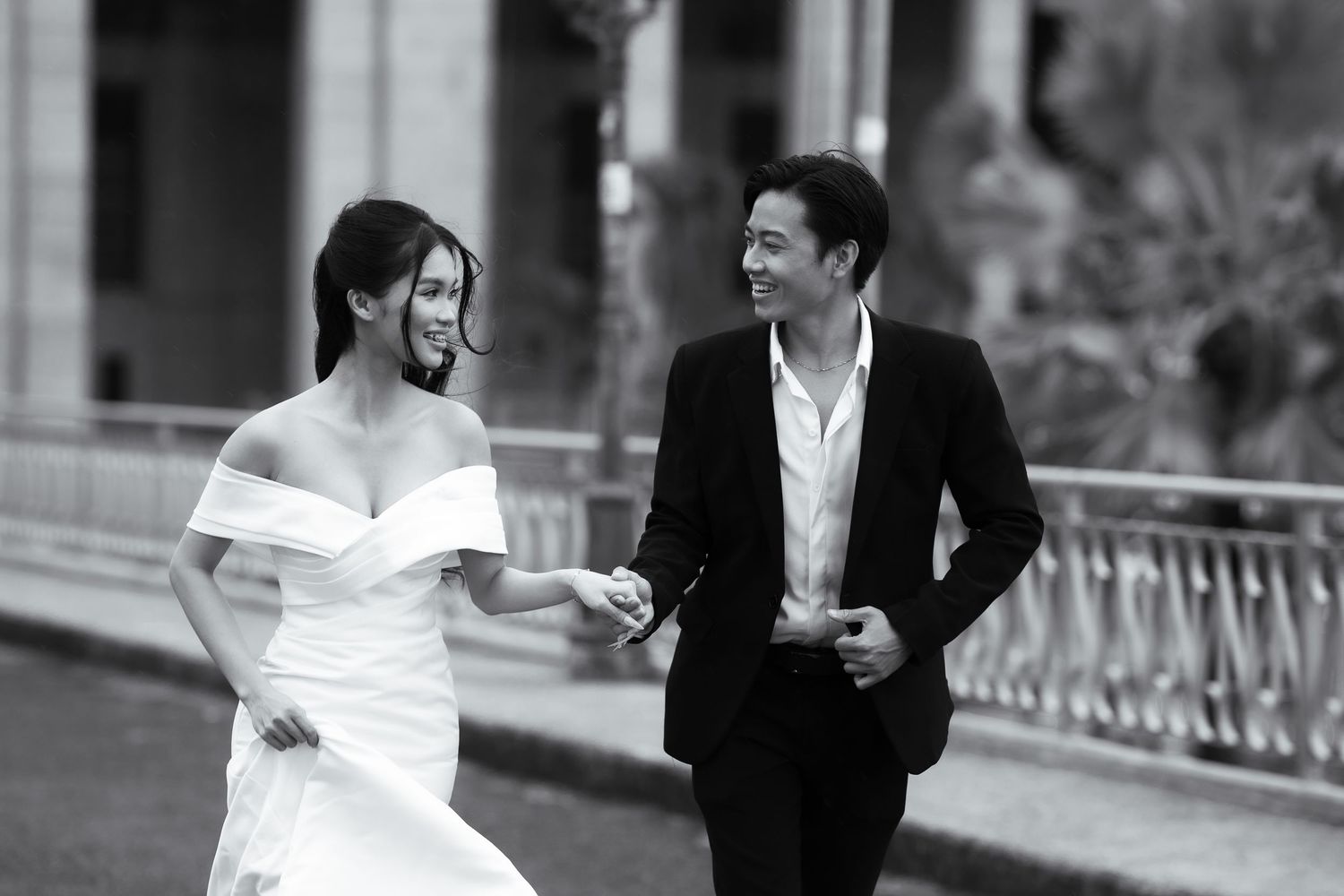 Black and white photo of couple walking together outdoors.
