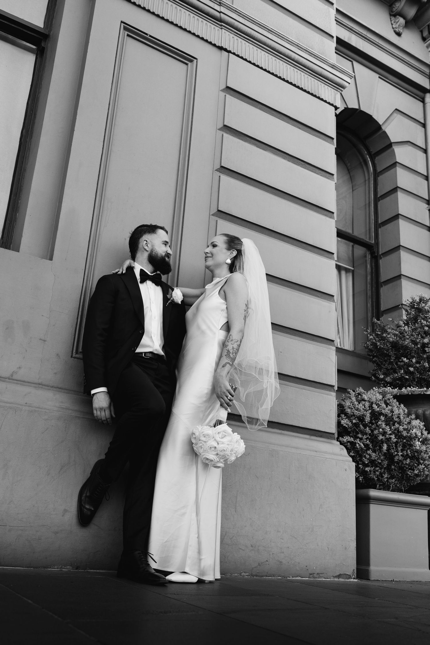 Black and white architectural wedding photos against classic building facade.