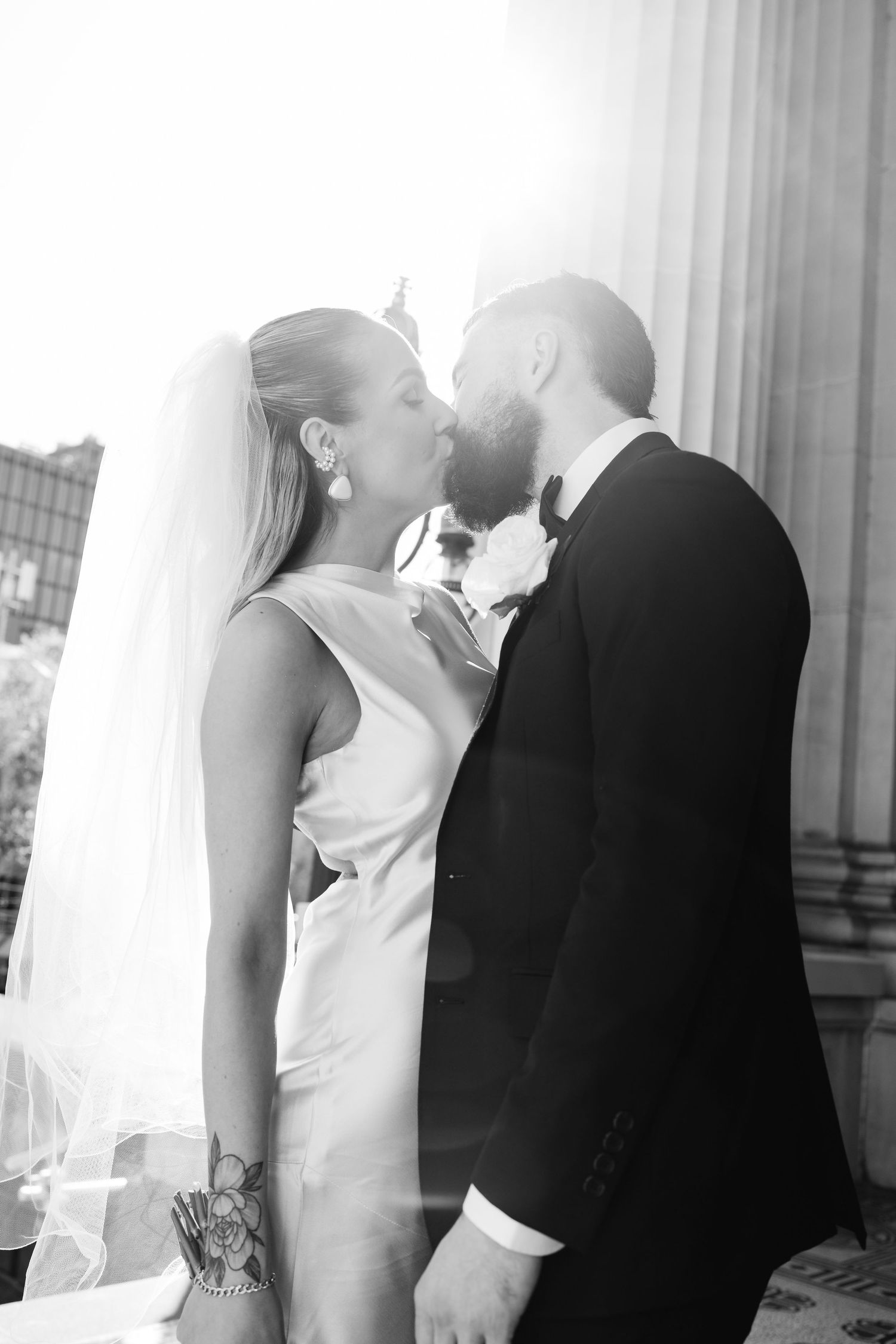 Artistic black and white wedding portraits showing intimate moments between couple.