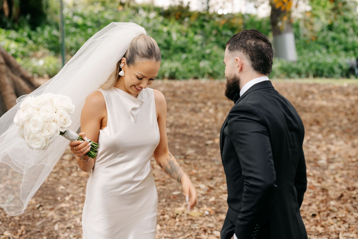 Wedding couple sharing first look moment in outdoor garden setting.