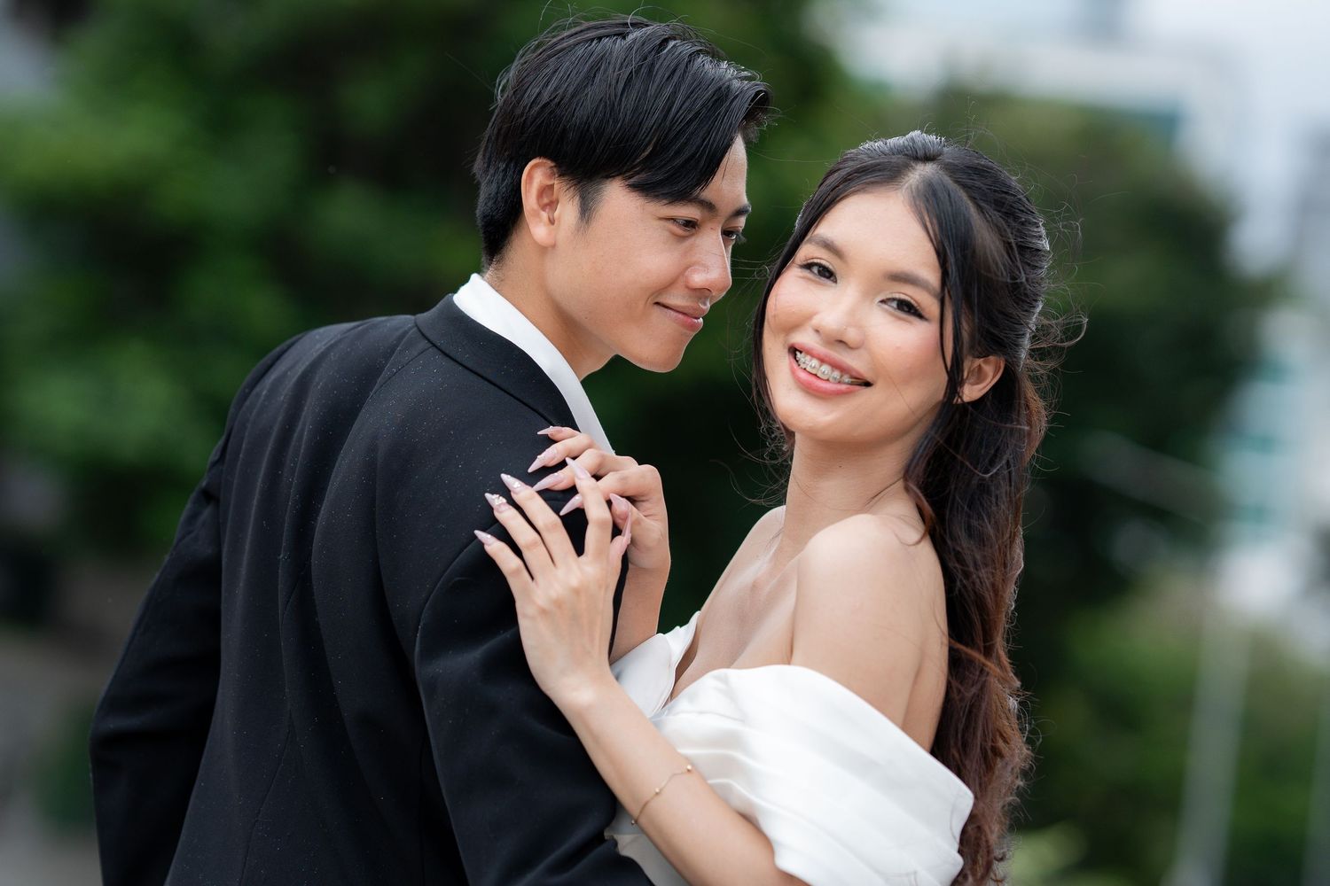 Romantic outdoor wedding photography session with couple in formal attire.