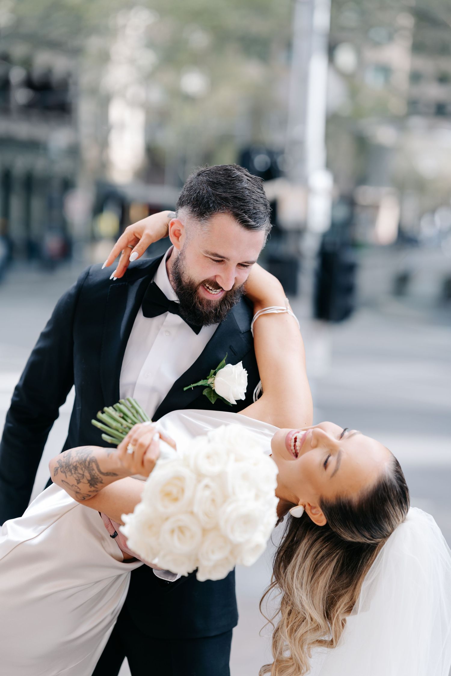 Romantic wedding dance poses captured in an urban setting with soft lighting.