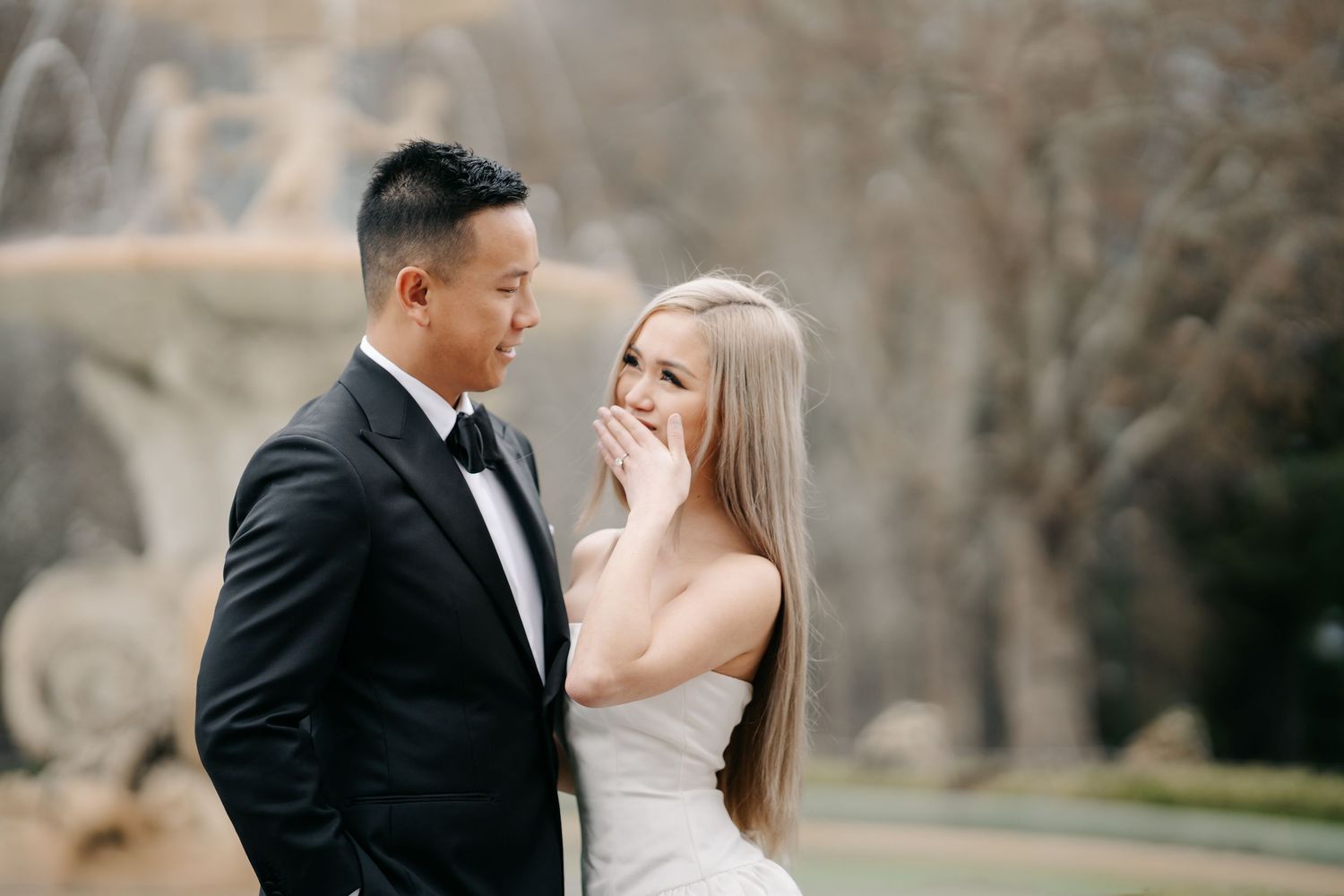 Intimate wedding portrait with couple sharing a tender moment outdoors.