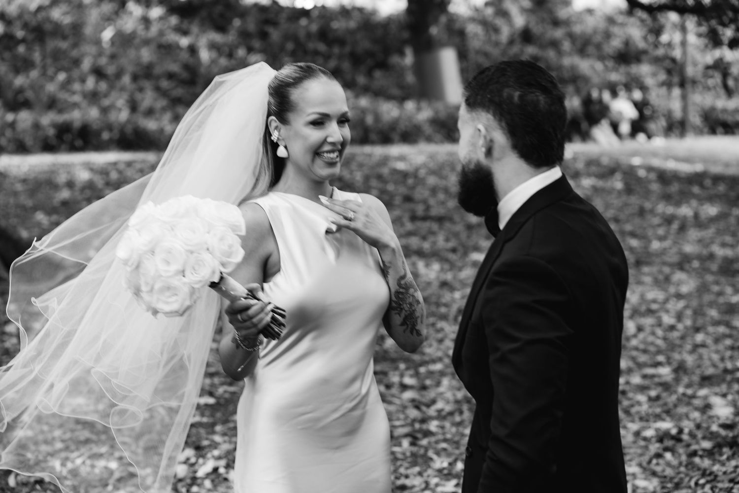 Black and white wedding portraits capturing candid moments of joy and laughter.