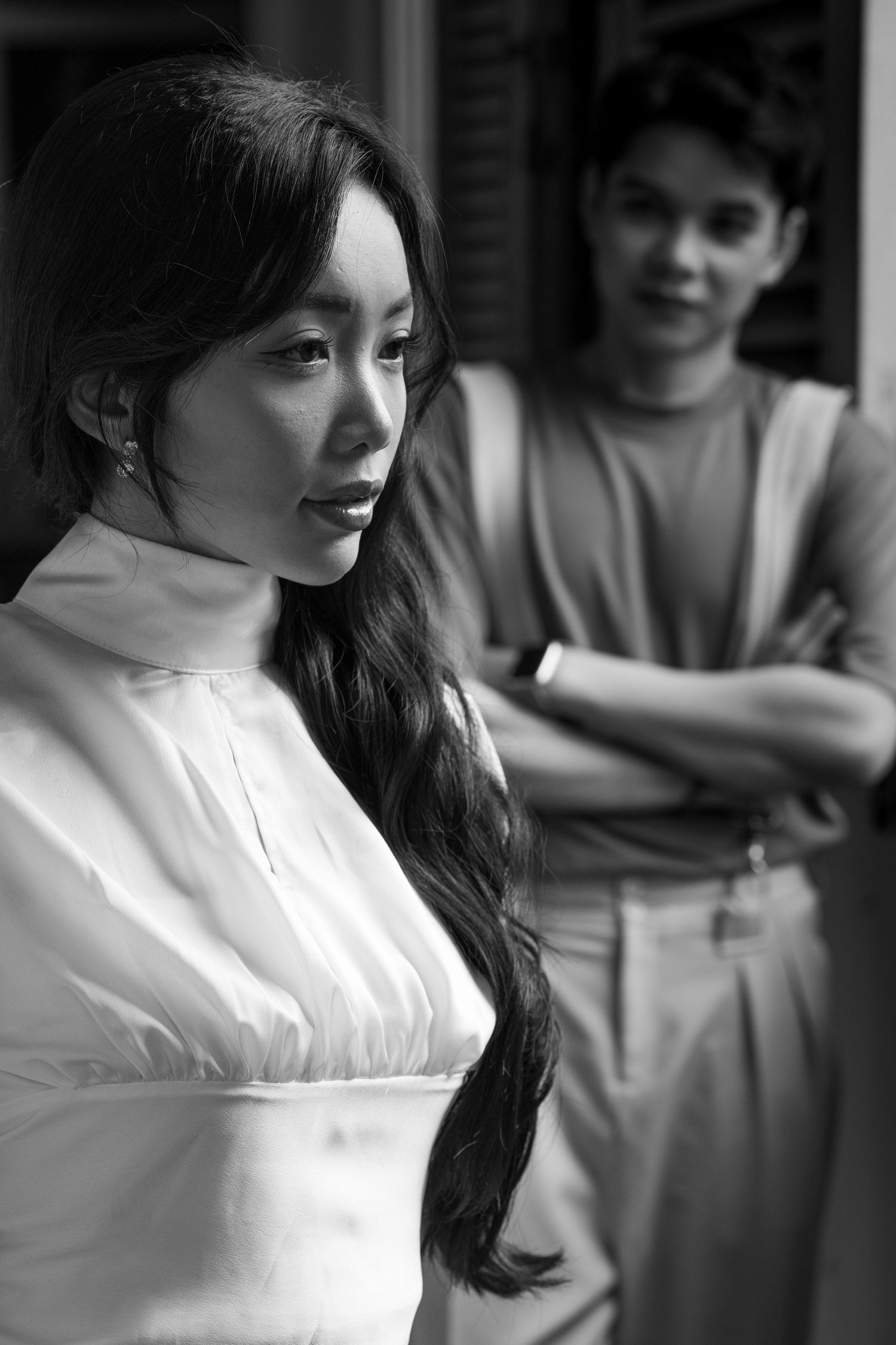 Black and white portrait series showing couple in casual indoor setting.