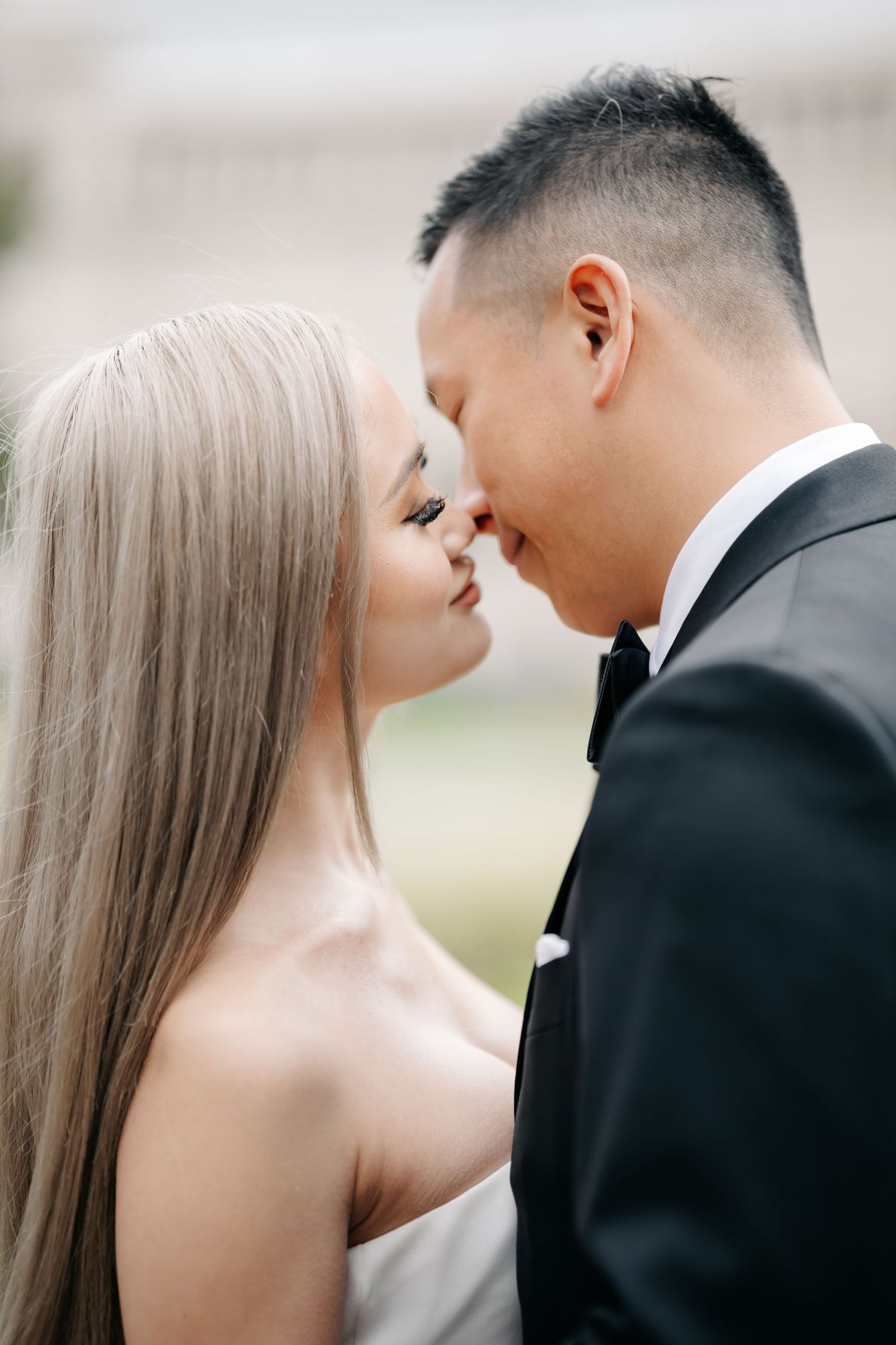 A tender moment between newlyweds as they share a romantic close-up kiss.