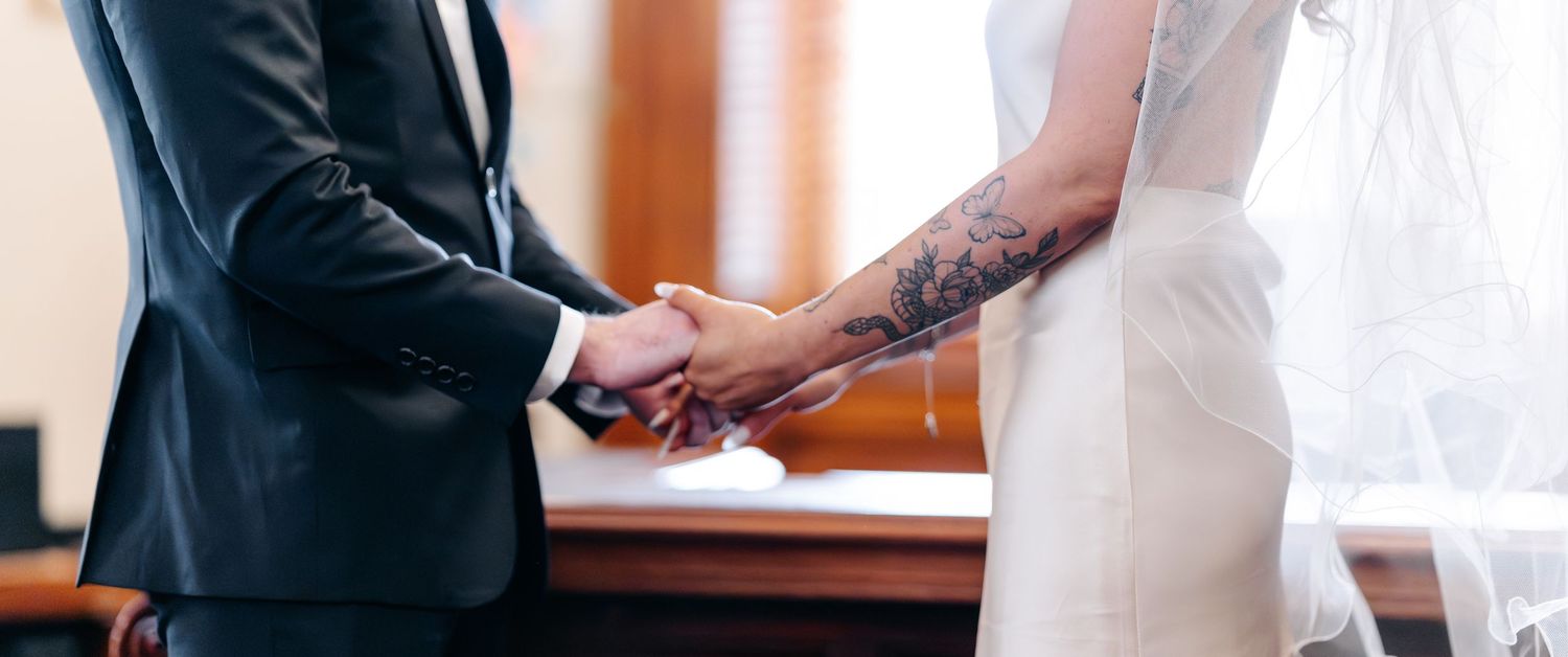 Wedding couple sharing a tender moment in an indoor venue.