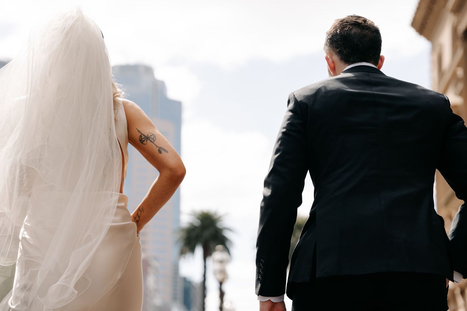 Silhouetted wedding couple poses against a bright background.