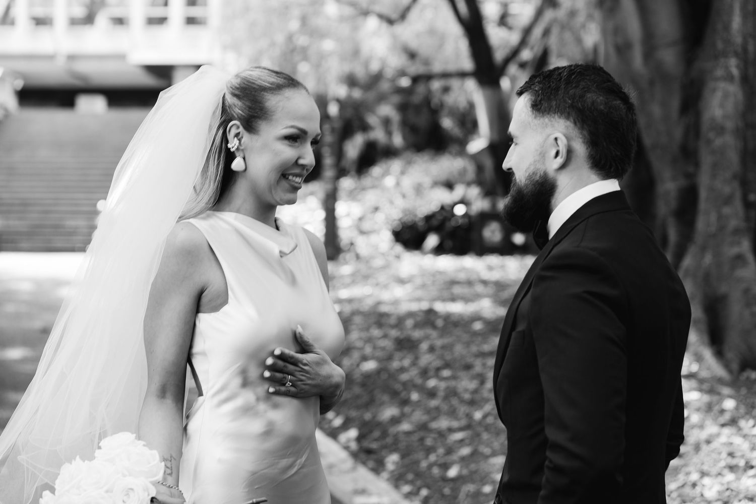 Black and white wedding portraits showing candid moments between the couple.