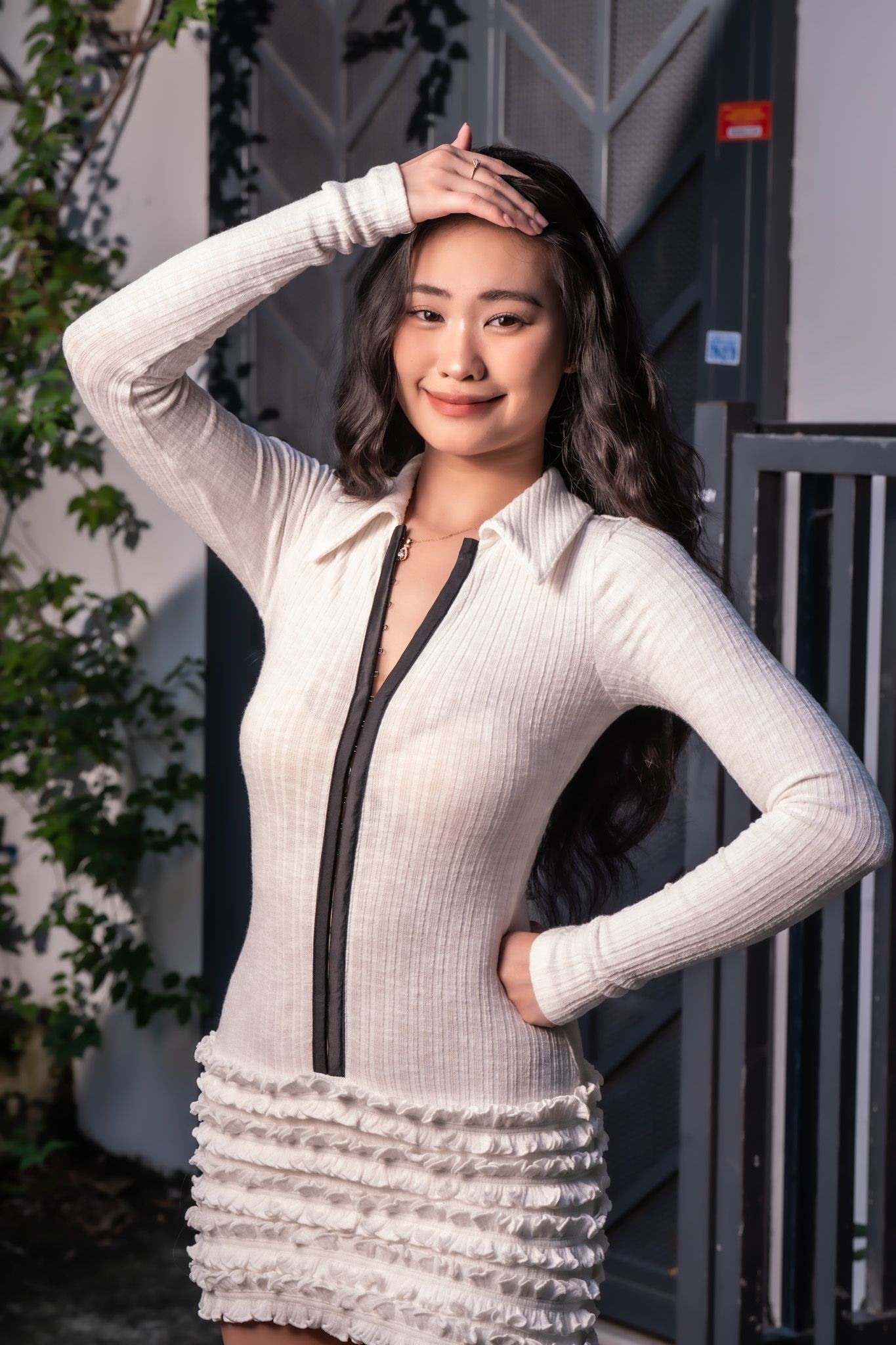 Fashion series featuring white ribbed dress with ruffle details against grey backdrop.