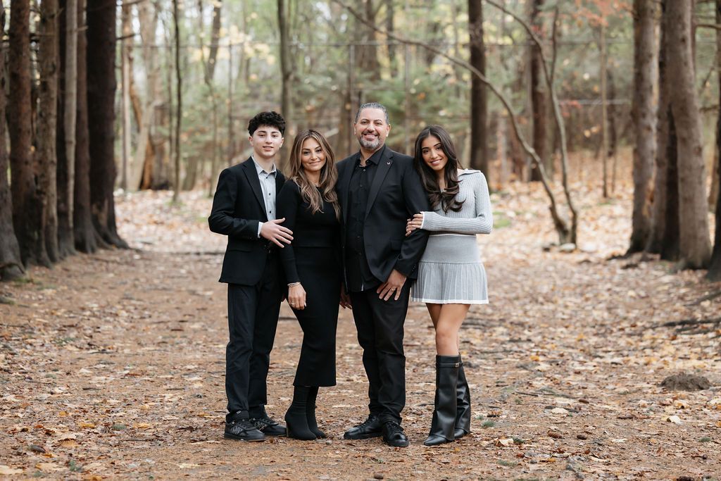 Group photo in a wooded forest path with fallen pine needles during autumn season.