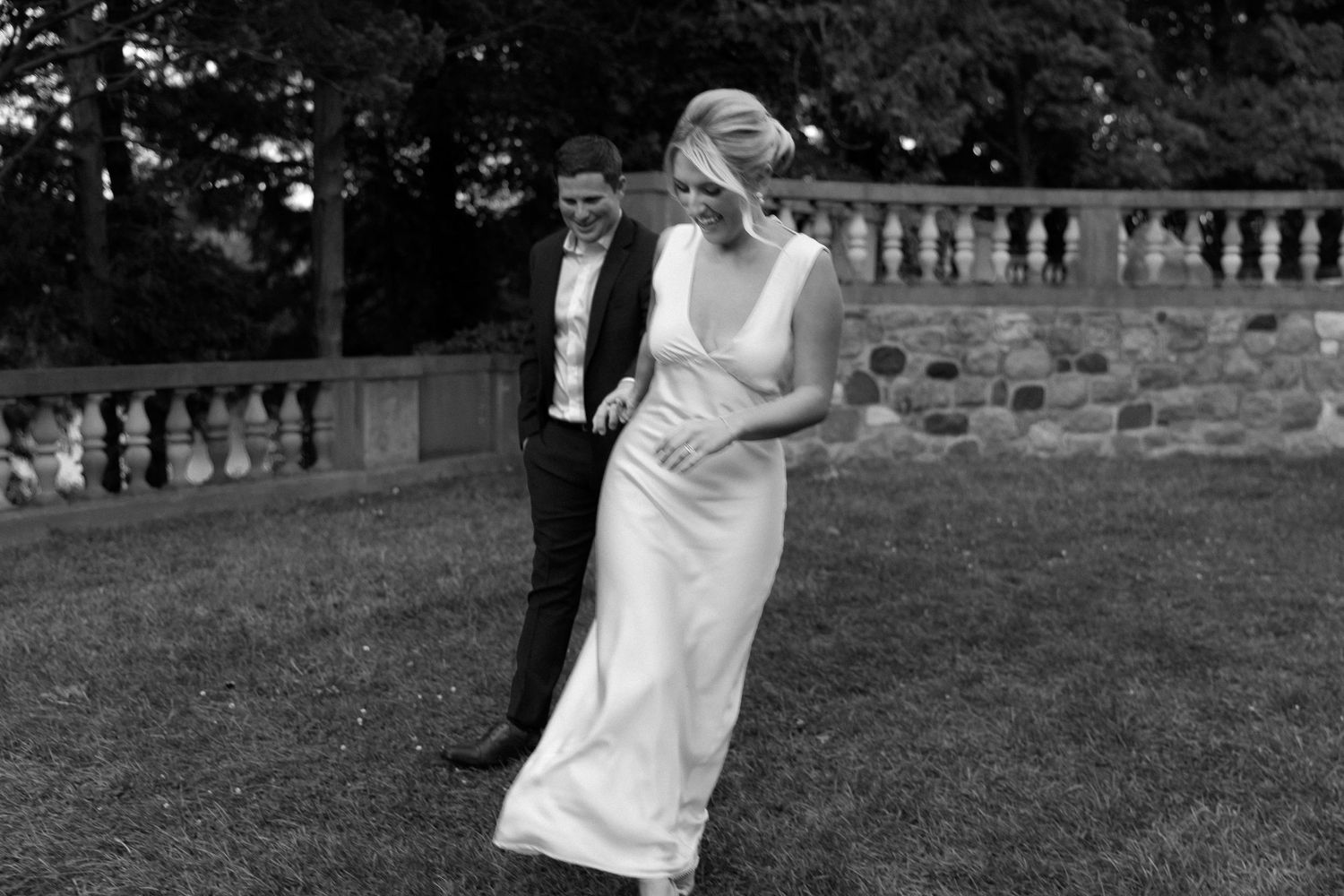 A couple dancing together on a stone terrace in black and white vintage style photography.