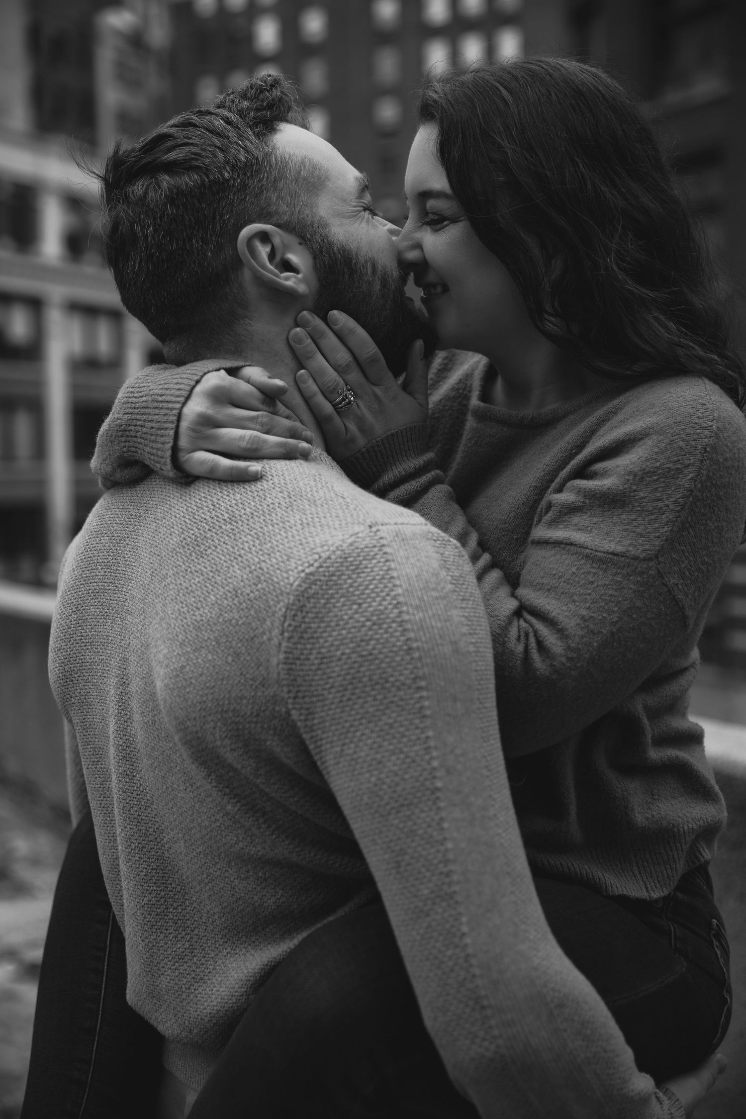 A tender moment captured between a couple in matching gray sweaters.