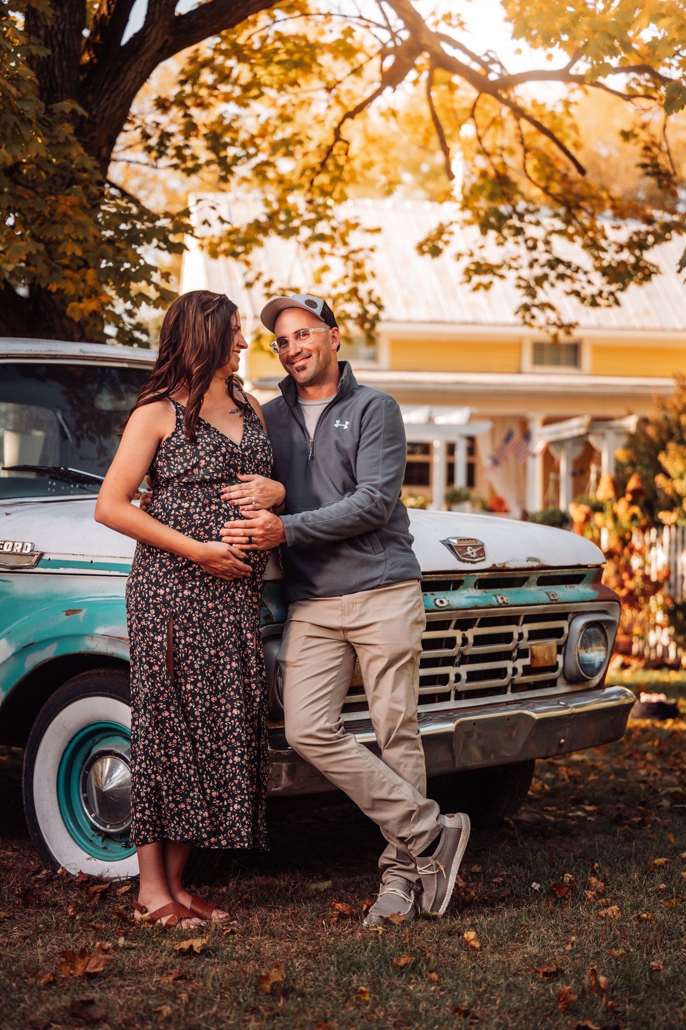 cute couple maternity photoshoot in front of old truck