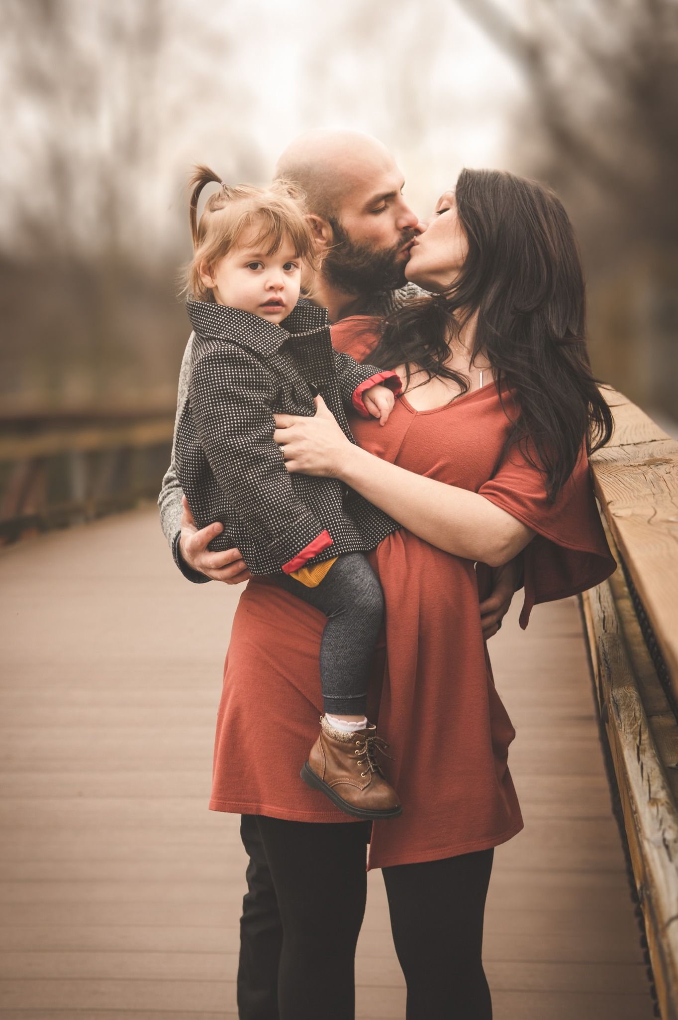 family of three on a bridge