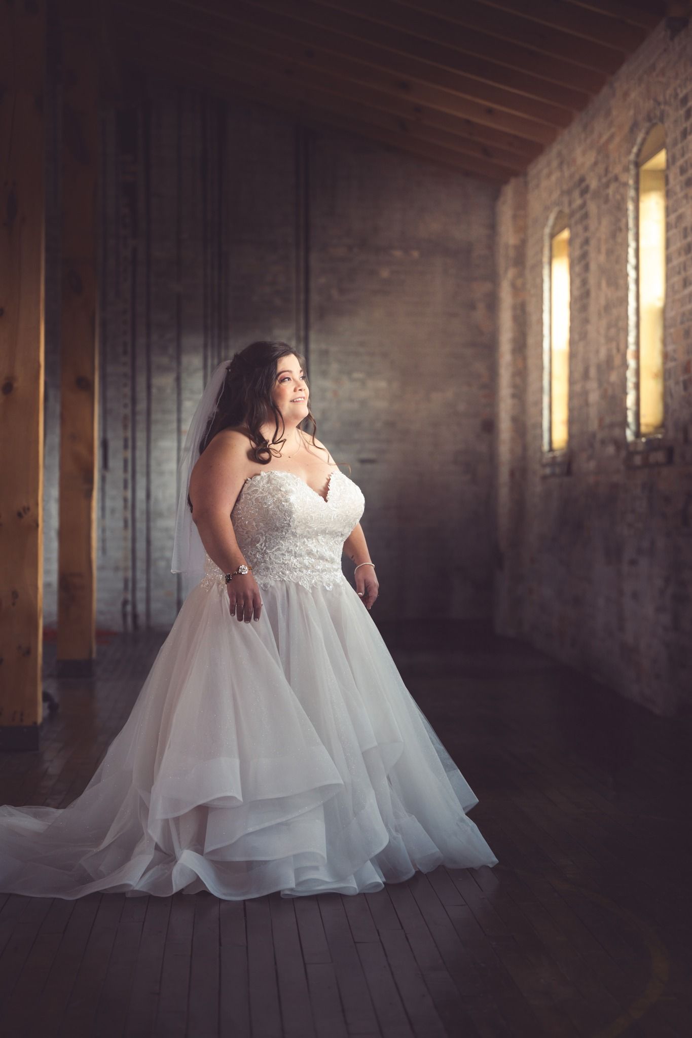 bride in a stone room looking out of the window