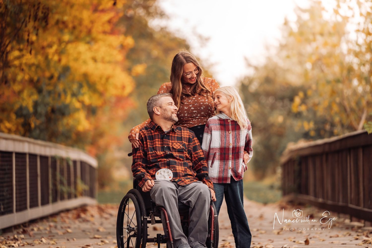 engagement photoshoot with wheelchair warm, dreamy, fall photography on bridge