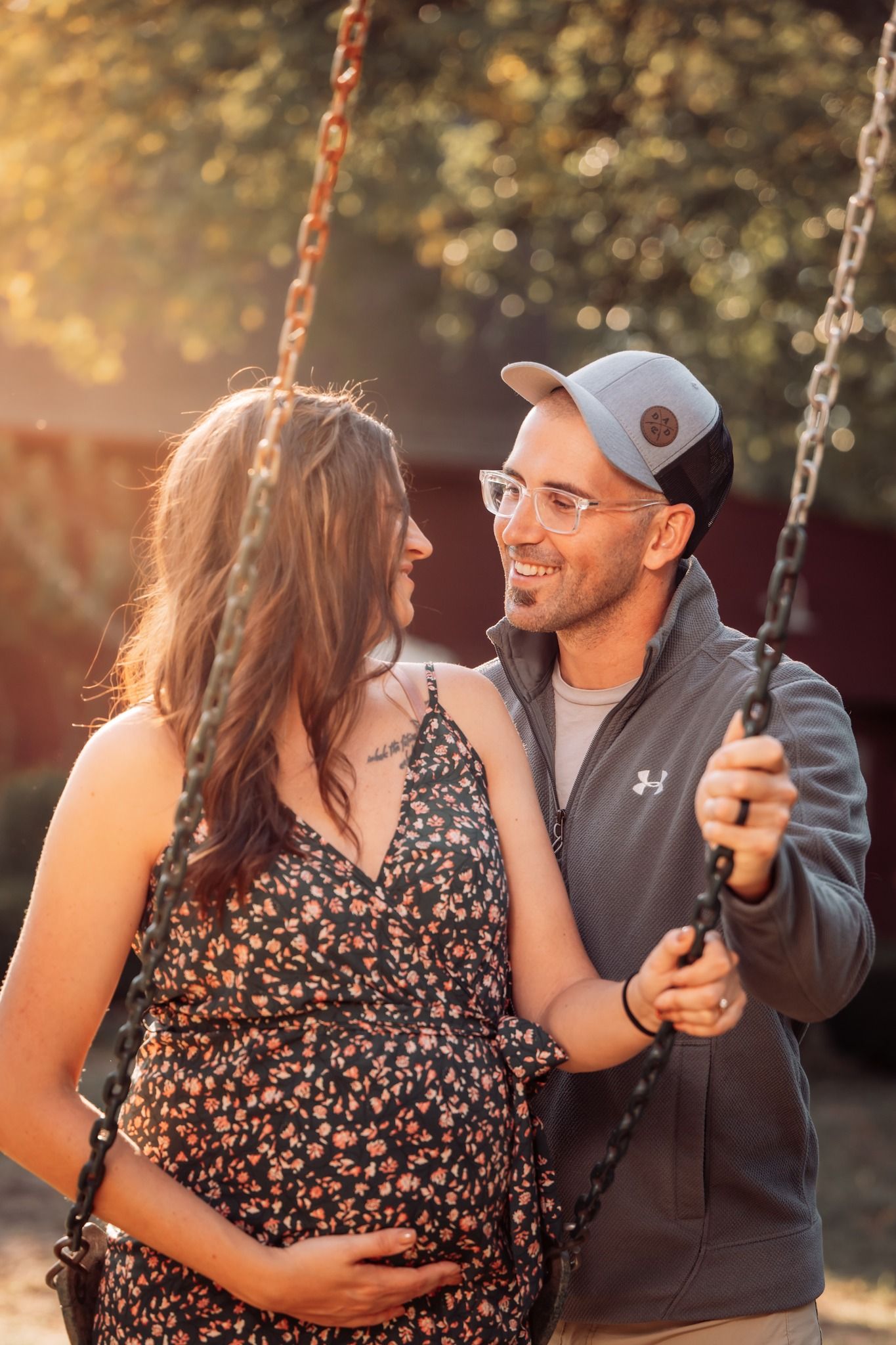cute couple on swing maternity photoshoot