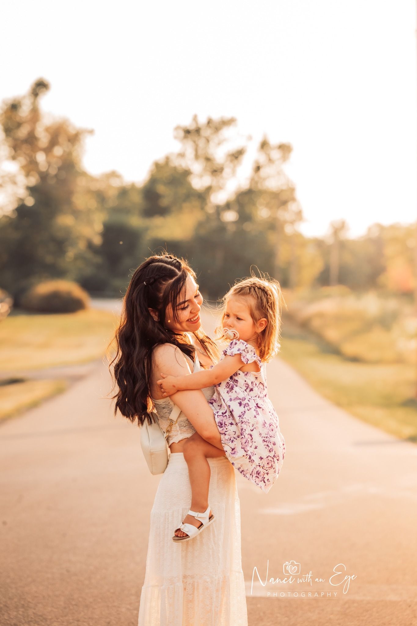 mother and toddler daughter on road in fall