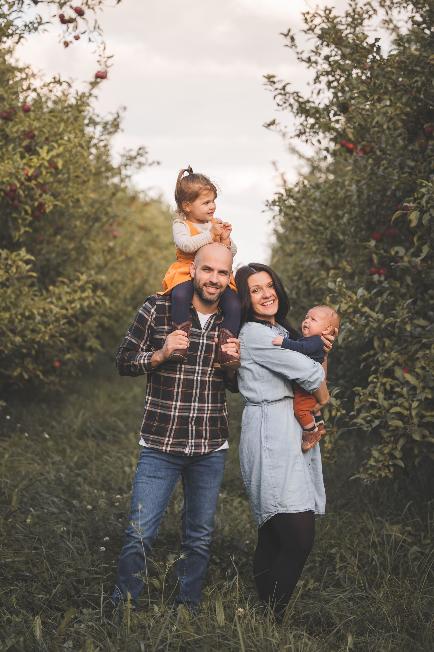 family of four in an orchard casual