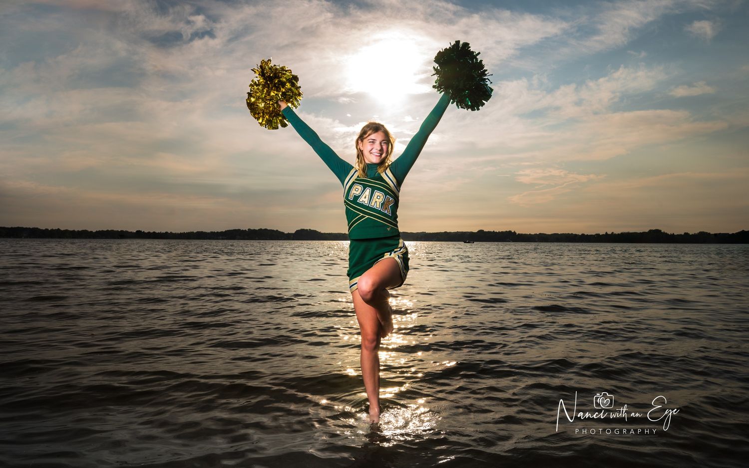 fun senior photoshoot cheerleader in the water splashing lake