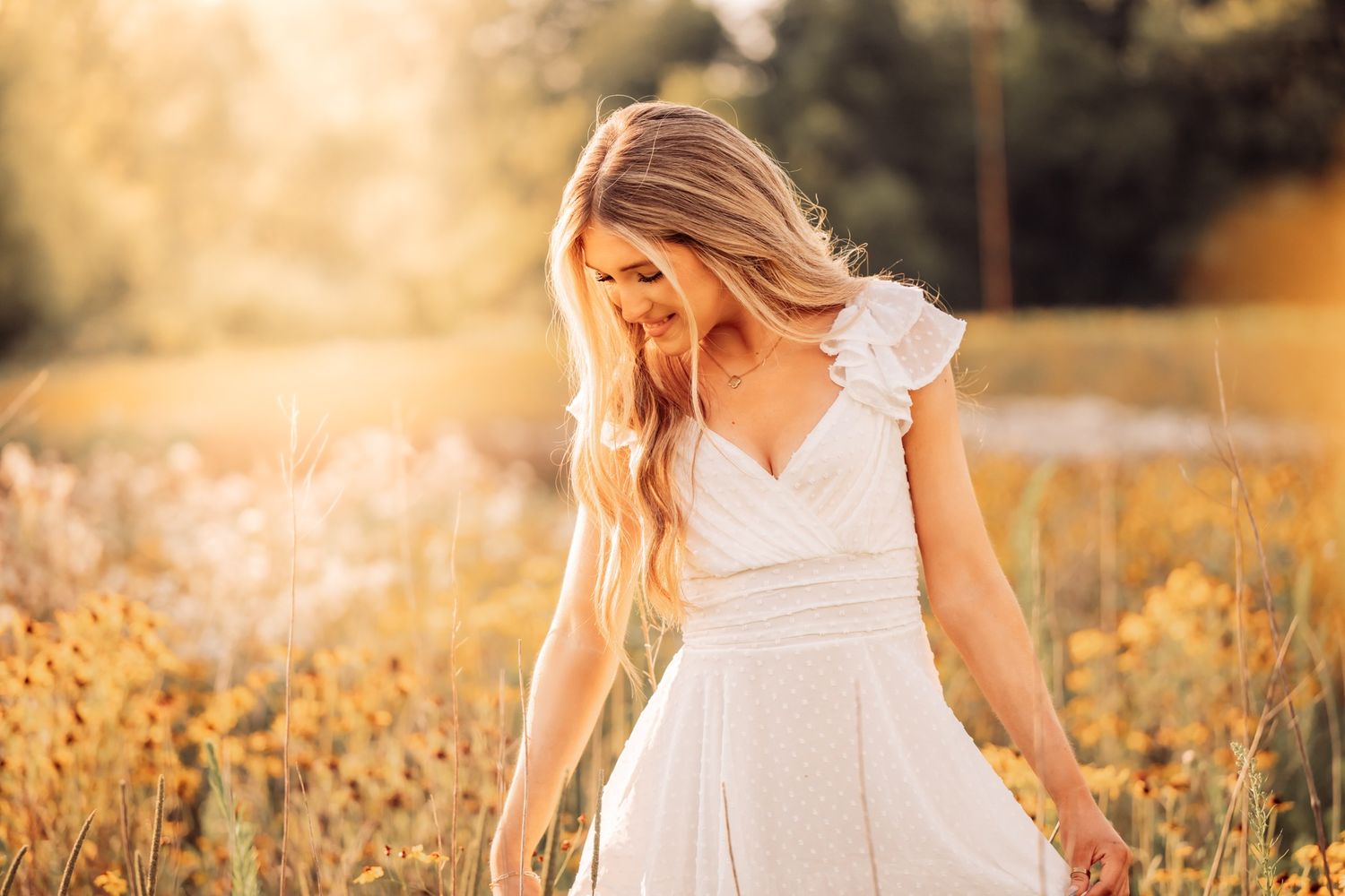 golden hour senior photo of girl in white dress in a field in the fall