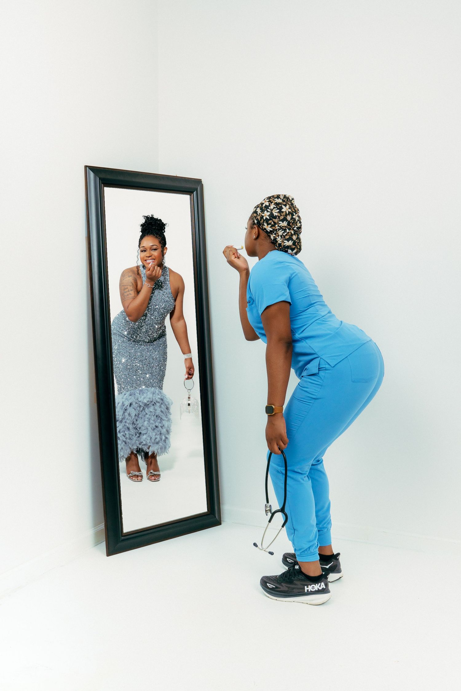 A series of playful poses showing someone interacting with a mirror in medical scrubs and a dress.