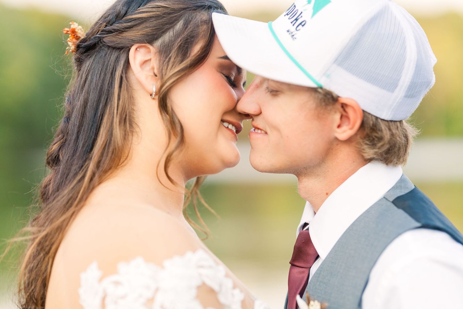 Intimate wedding photo of couple sharing a romantic moment outdoors.