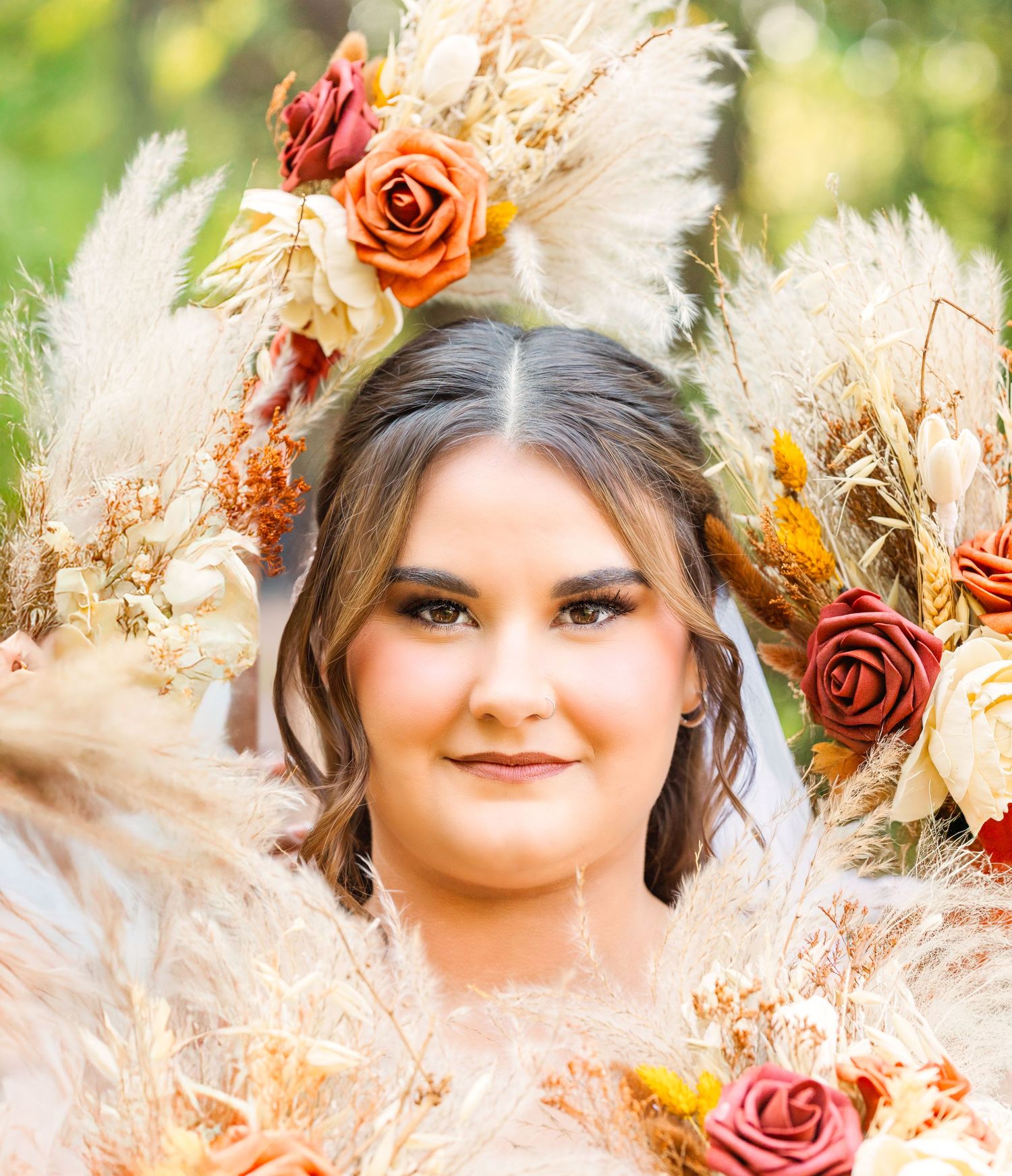 Portrait surrounded by dried flowers and roses in warm autumn colors.