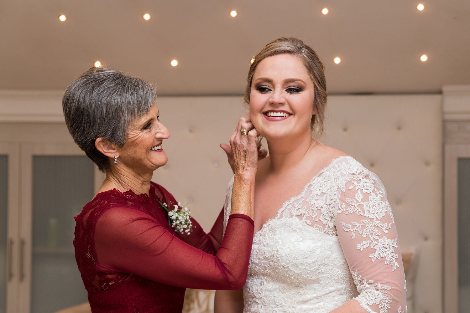 Wedding dance photos show emotional moments between loved ones during reception in a beautifully lit venue setting.