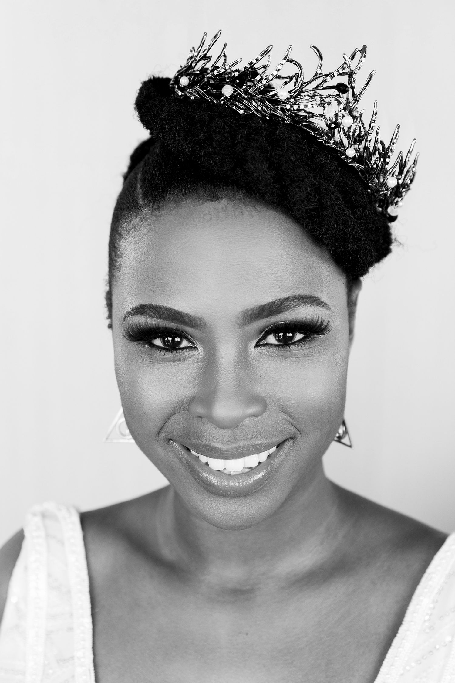 Professional black and white portrait series showing warm smiles and natural hairstyles against a white backdrop.