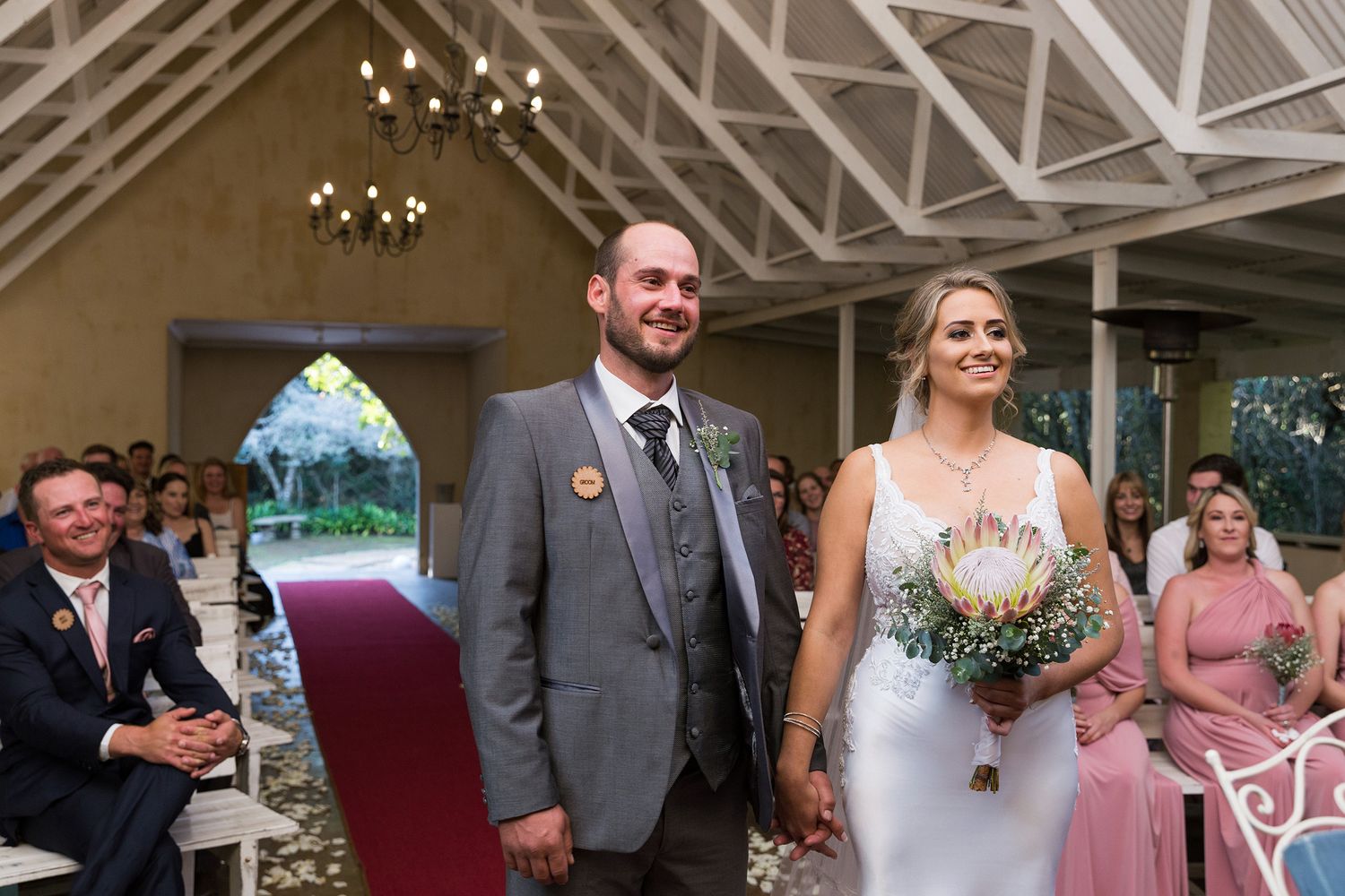 A sequence of wedding moments showing couples and guests celebrating in a rustic indoor venue with hanging lights.