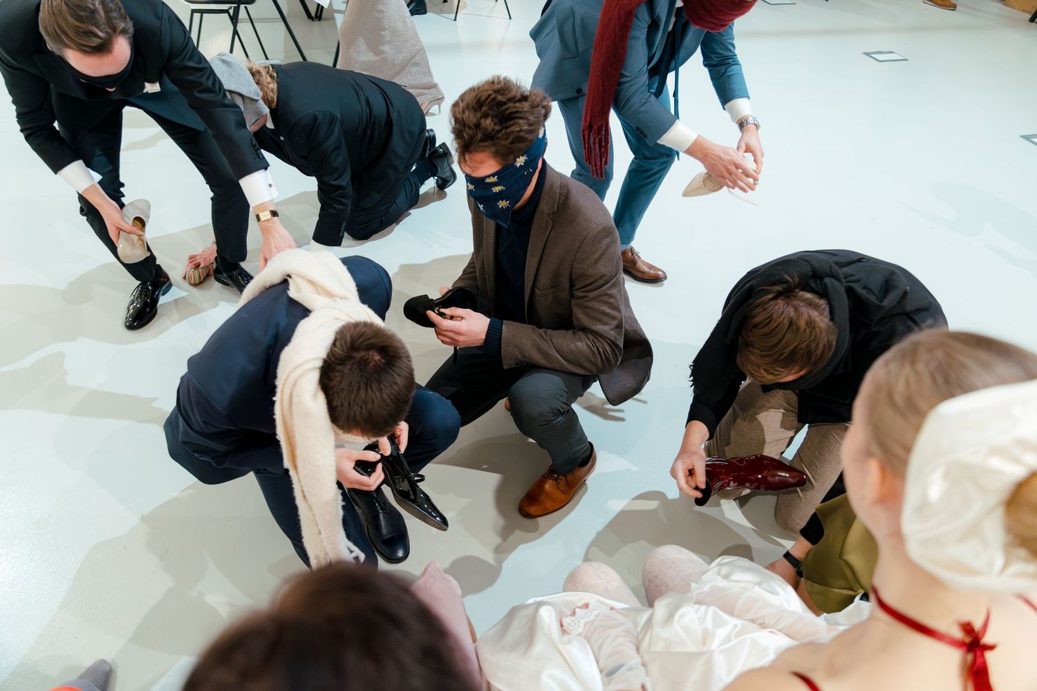 Wedding guests gather on a white floor during a celebration event.