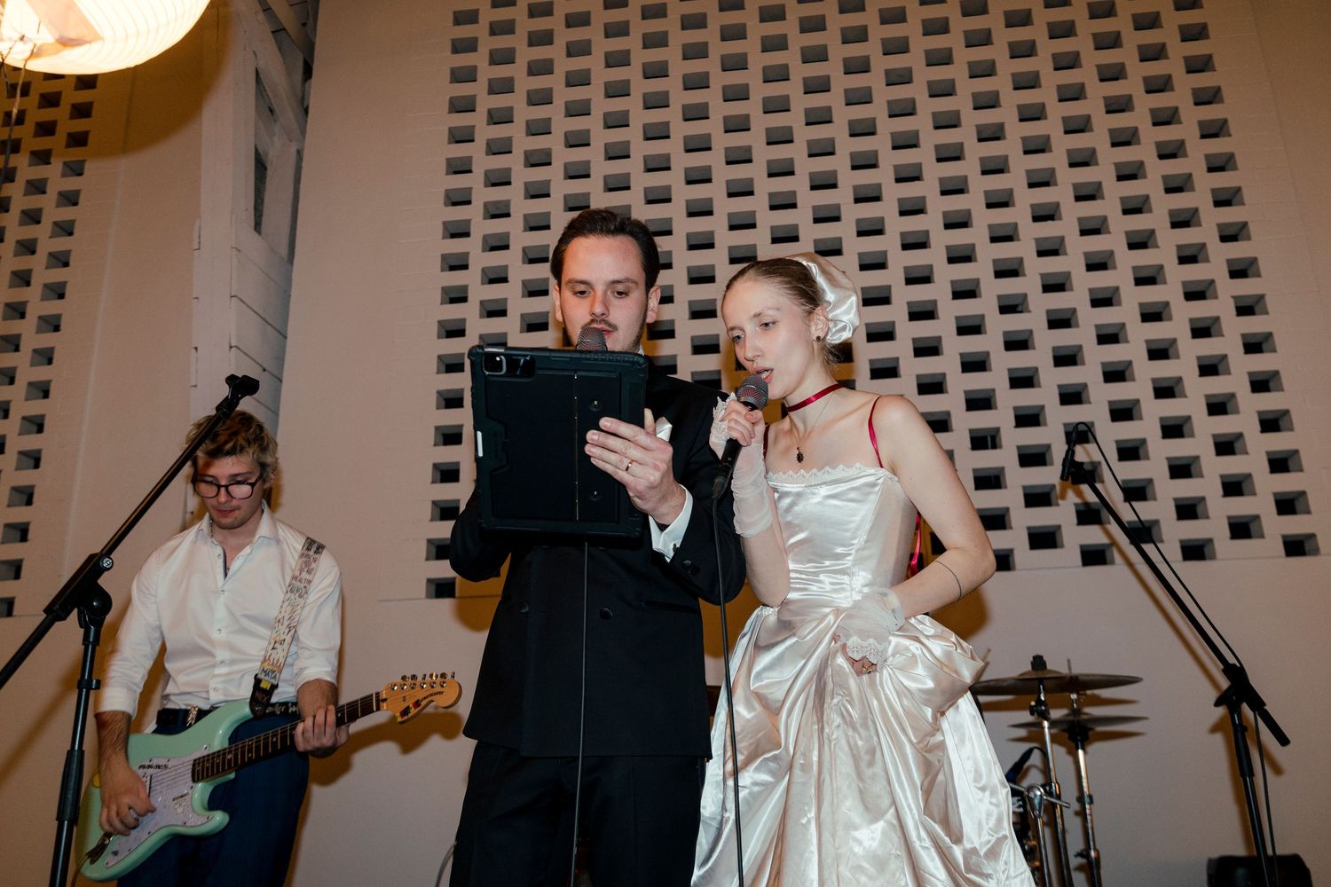 Wedding reception entertainment with musicians performing on stage.
