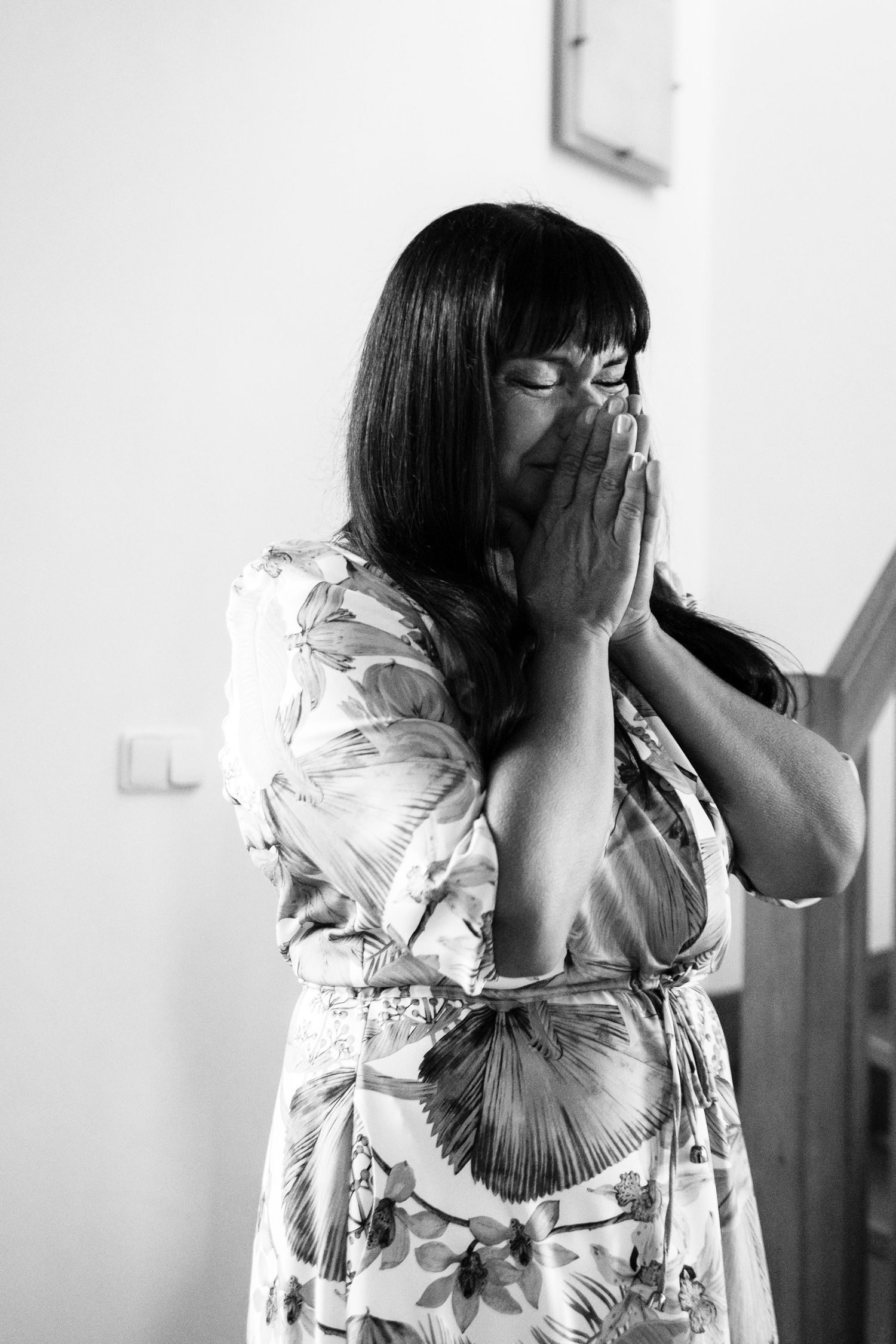 Sequence of black and white photos showing emotional moments in a bright interior setting.