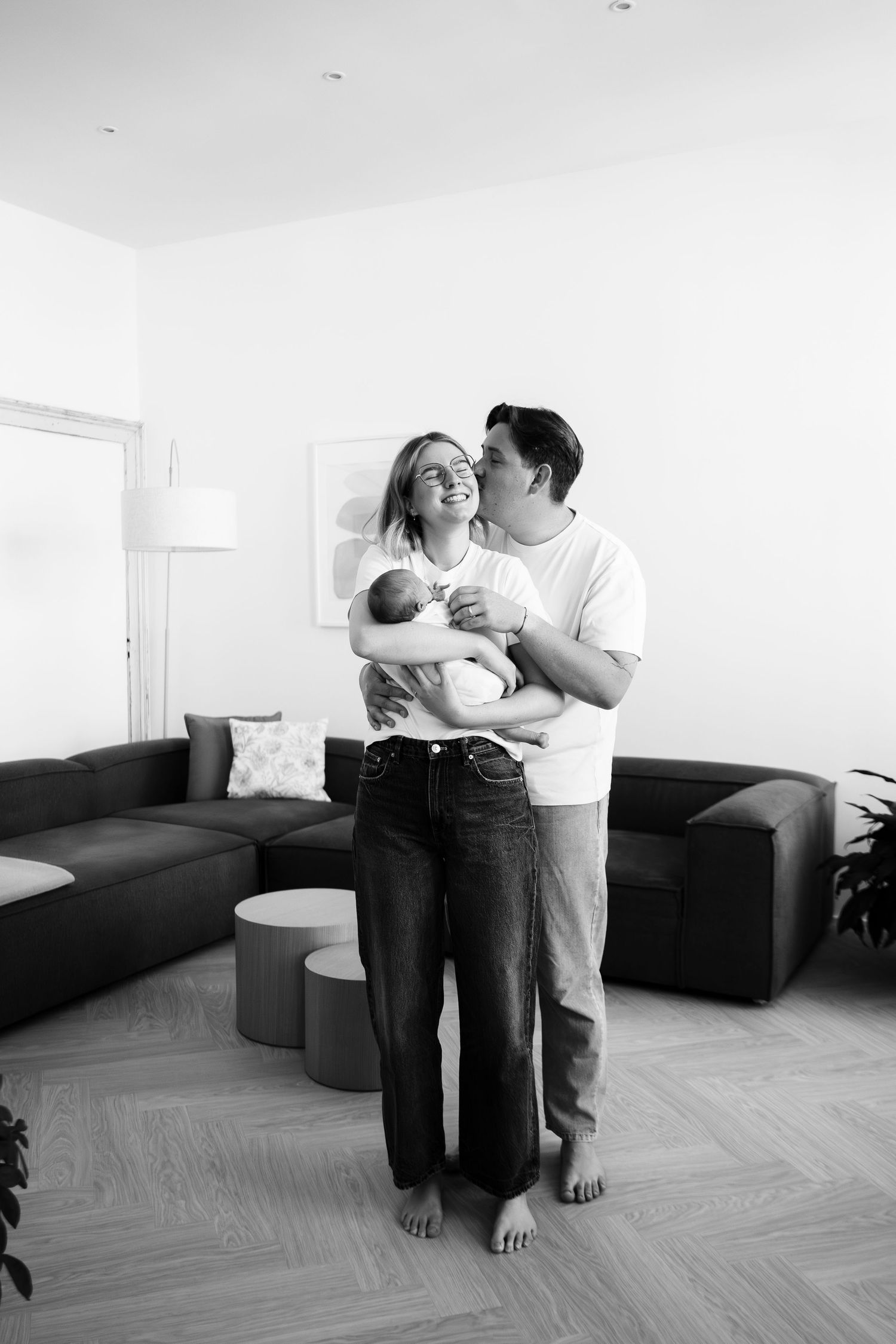 Black and white series of dancing figures in a minimalist white room with parquet flooring.