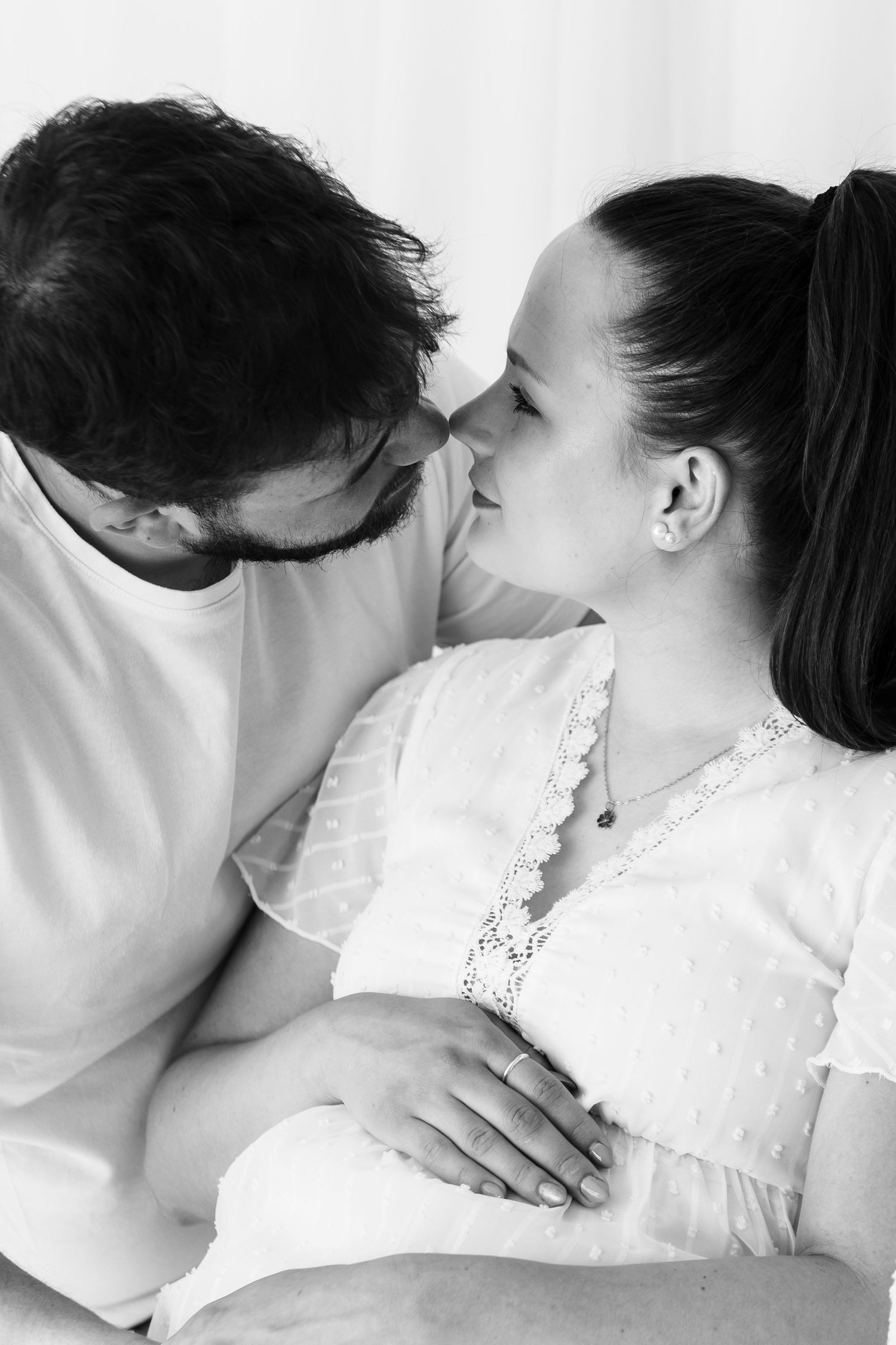Black and white intimate portrait series with soft lighting and white clothing.