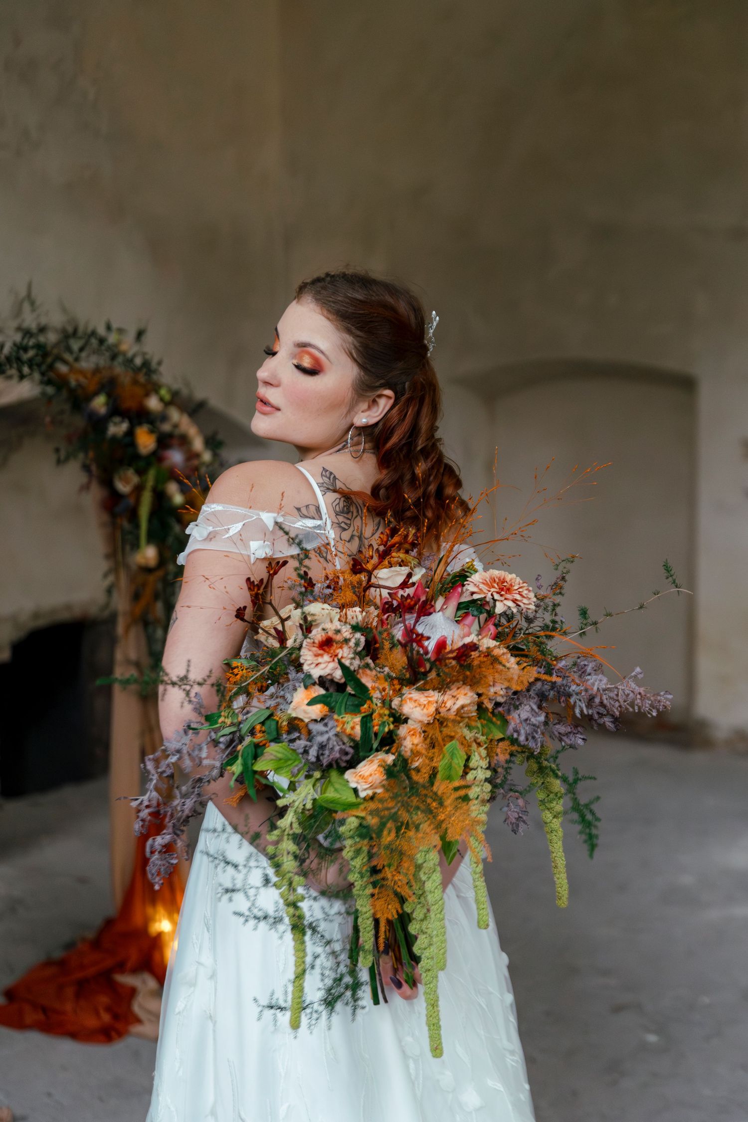 Bride holding vibrant autumn floral bouquet in artistic poses.