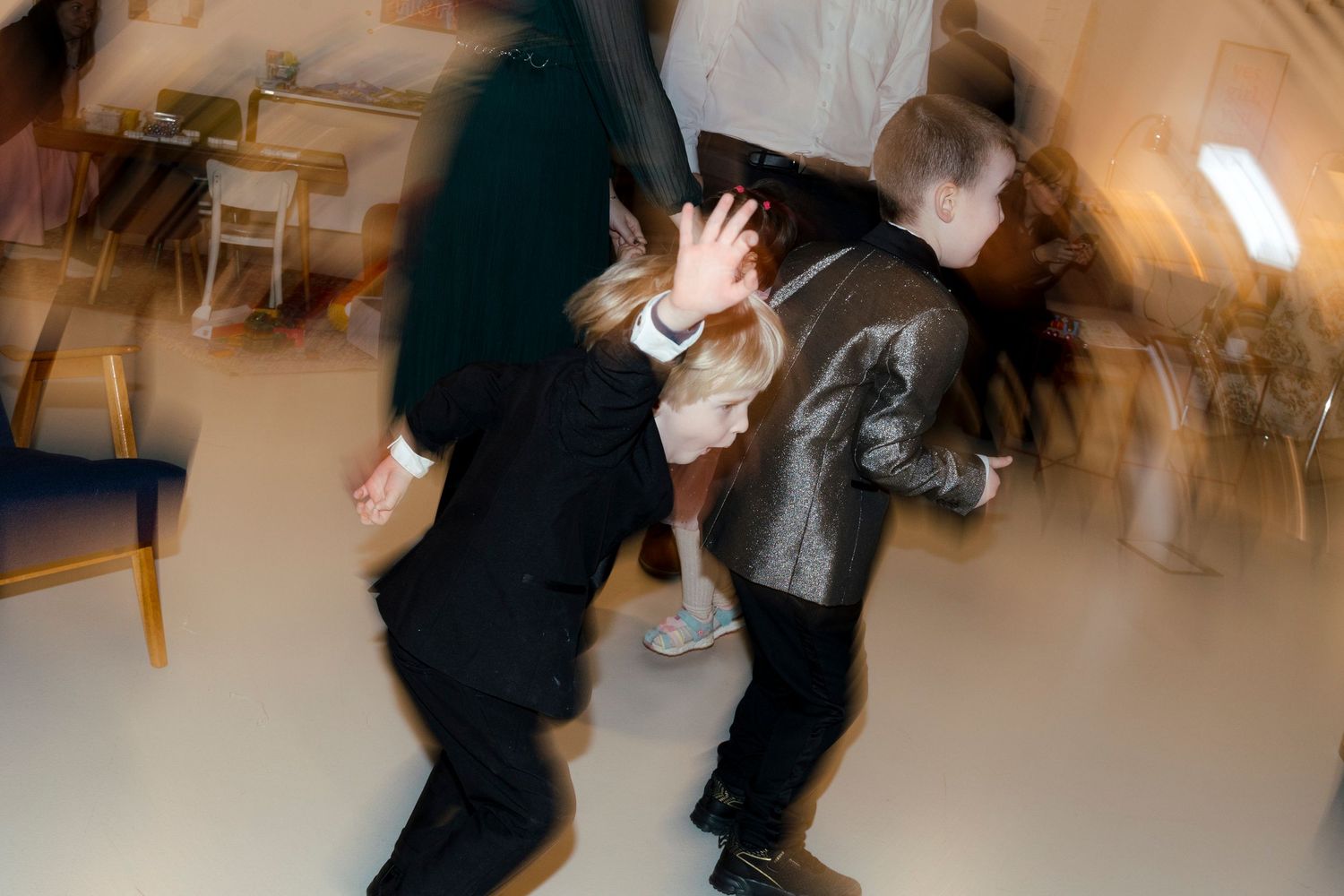 Motion-blurred photo of people dancing at a celebration.