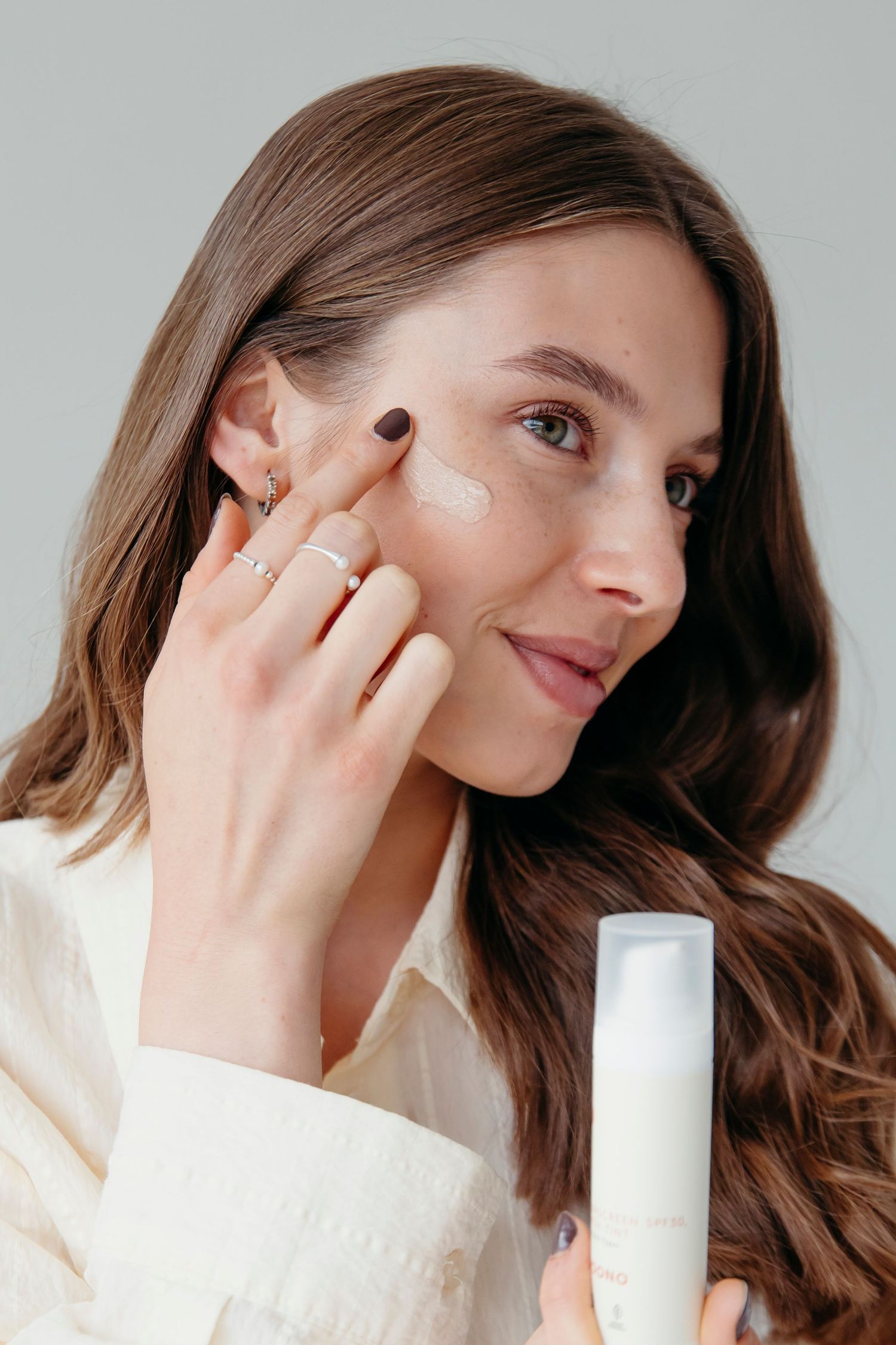 Beauty routine demonstration showing application of skincare product.