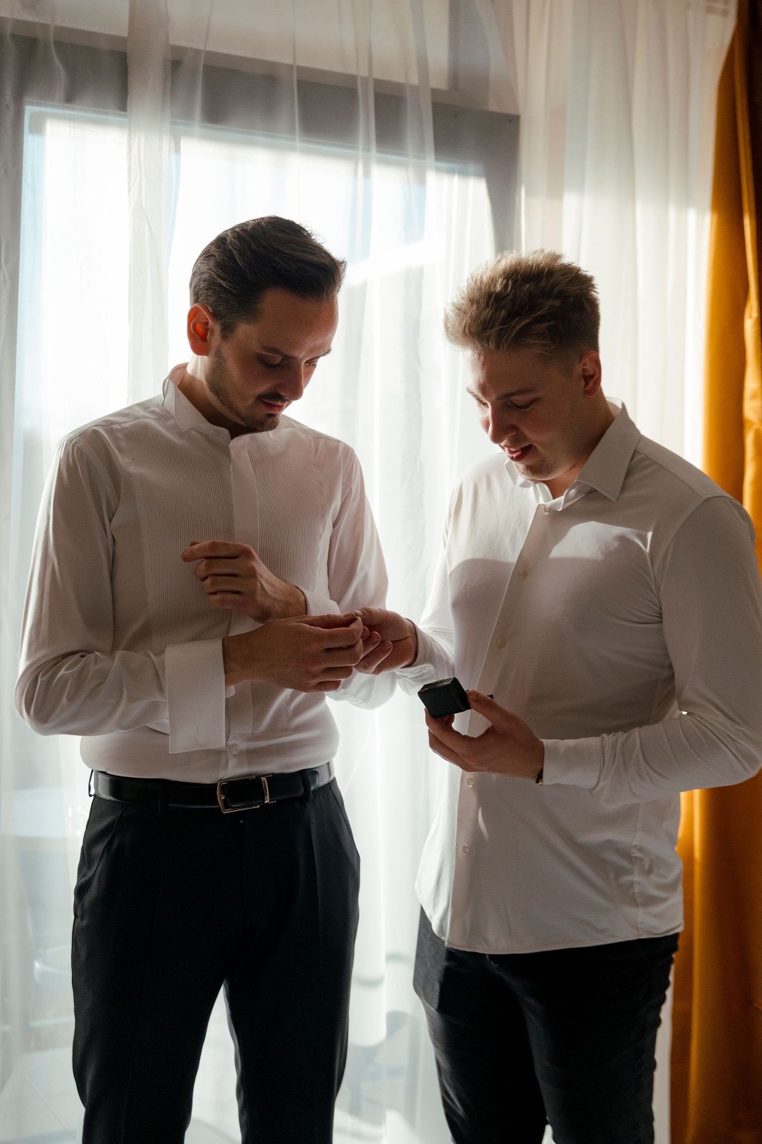 Two people in white shirts sharing a lighthearted moment together.