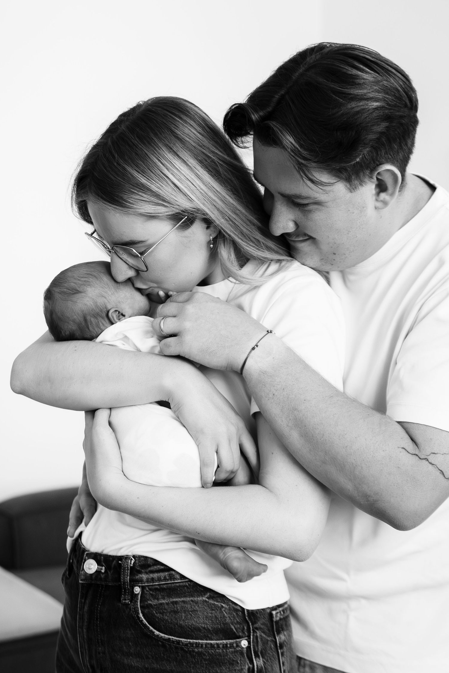 Black and white intimate portrait series showing tender family moments.