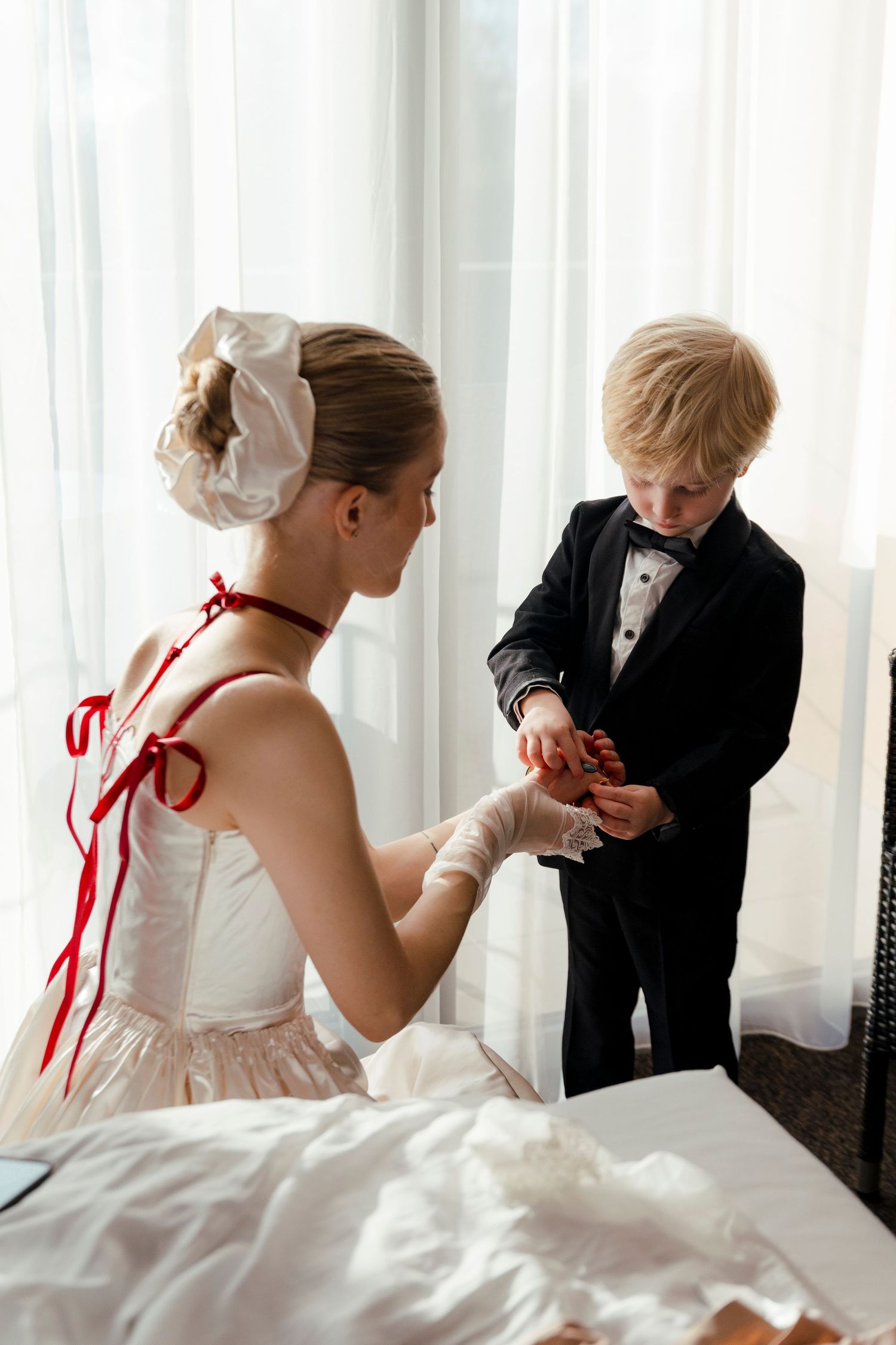A tender moment shared between two people in formal wedding attire.