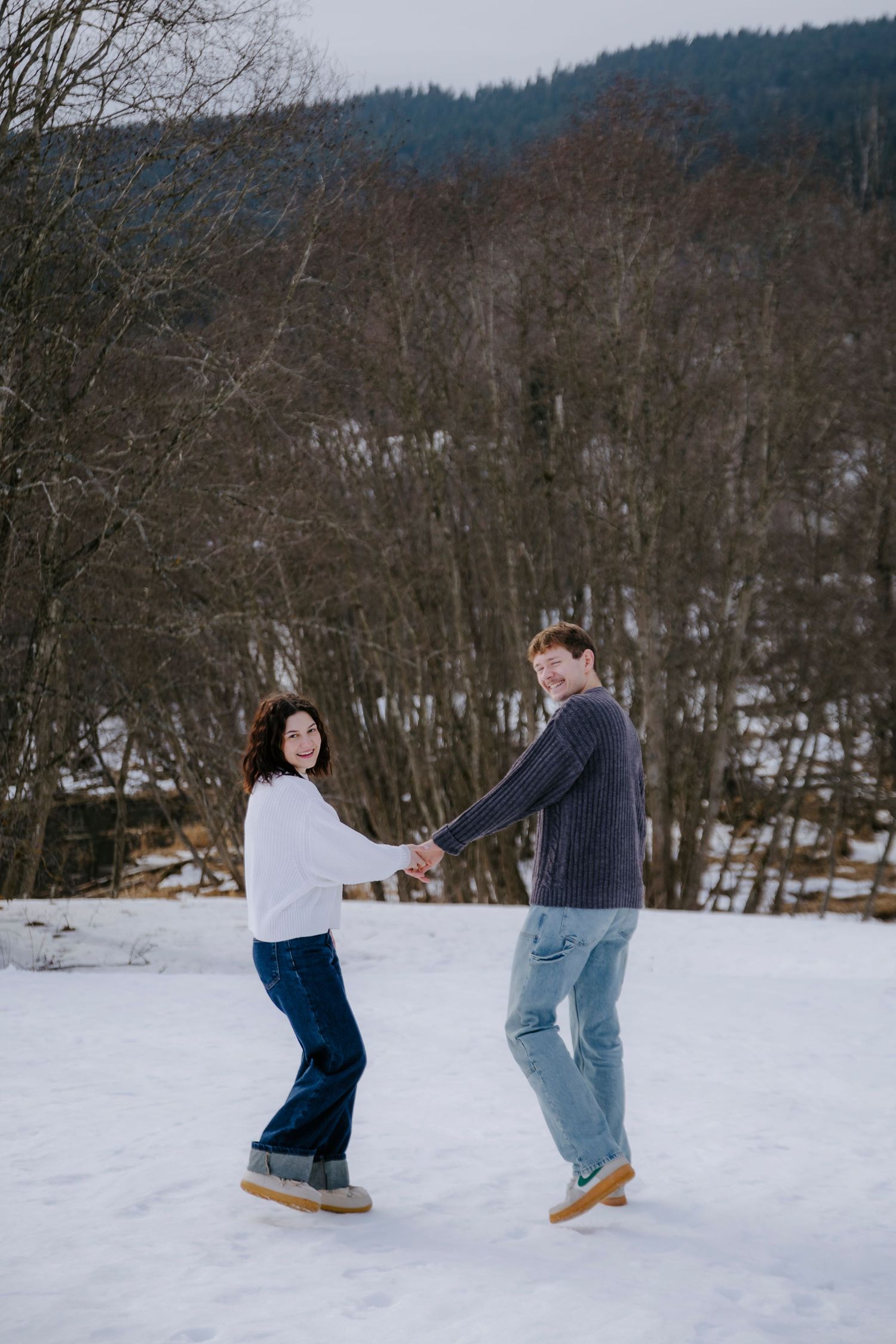 Playful sequence of people in winter scene with snow-covered ground.
