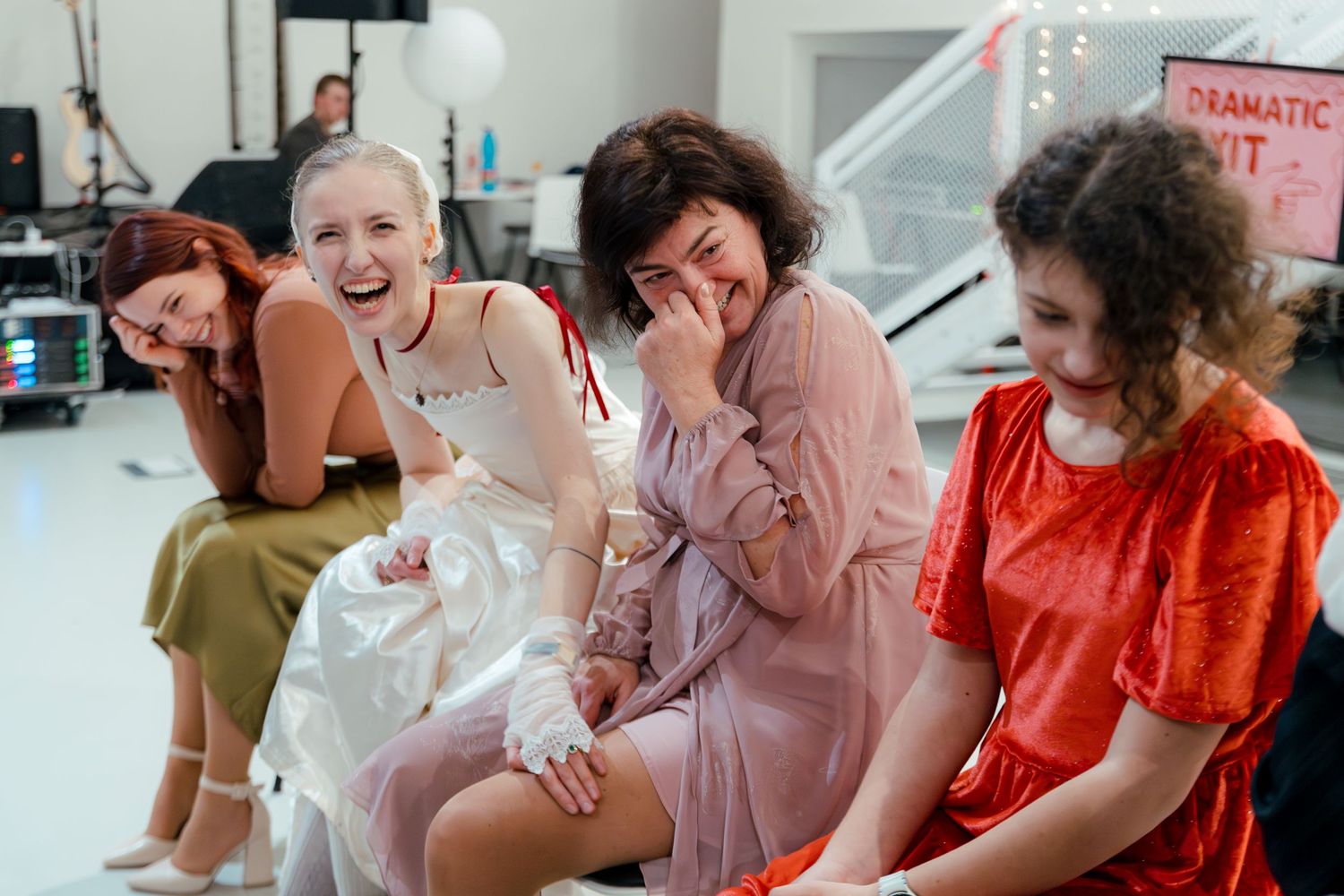 Wedding guests laugh and socialize during a reception celebration.