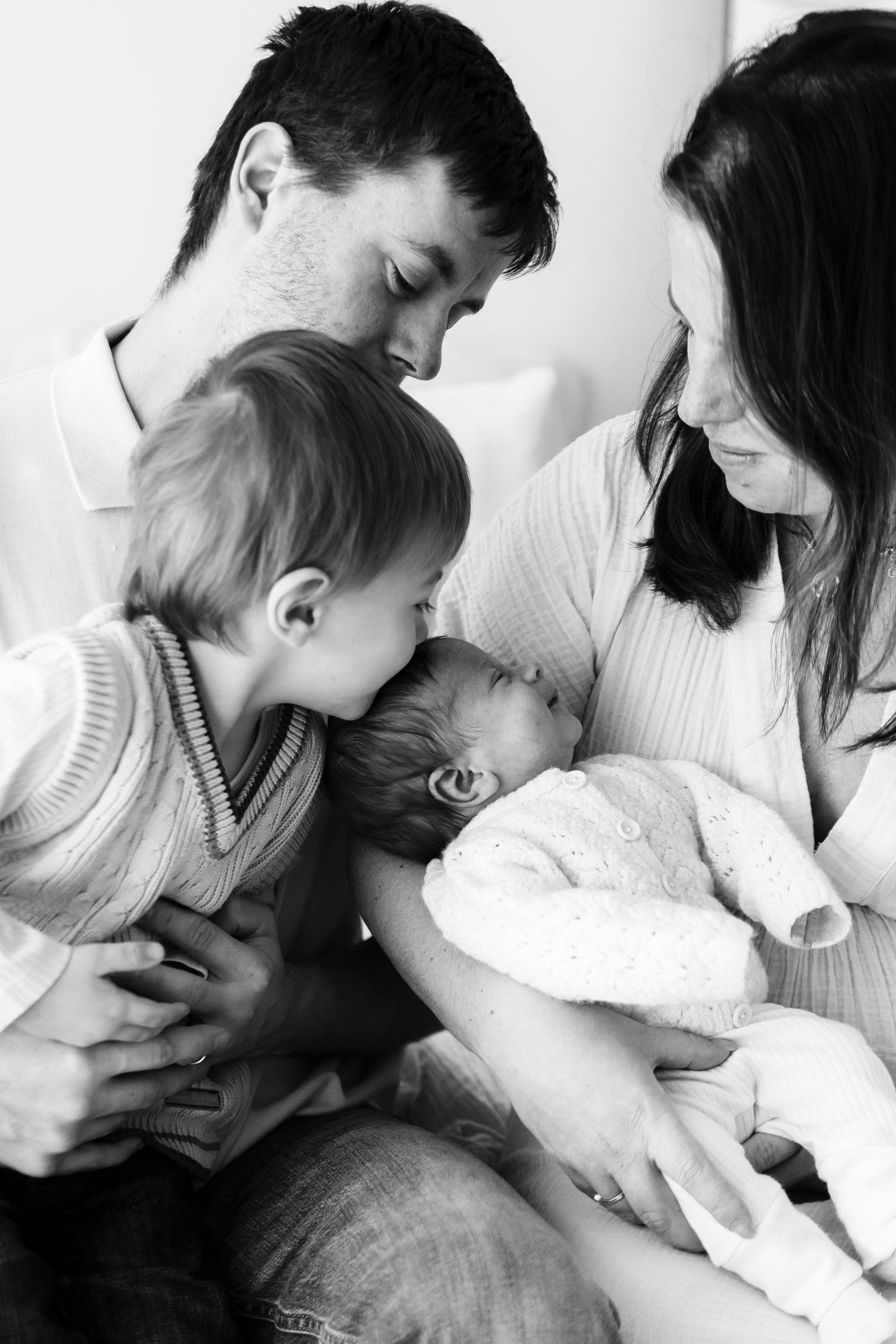 Intimate black and white photos showing tender family moments.
