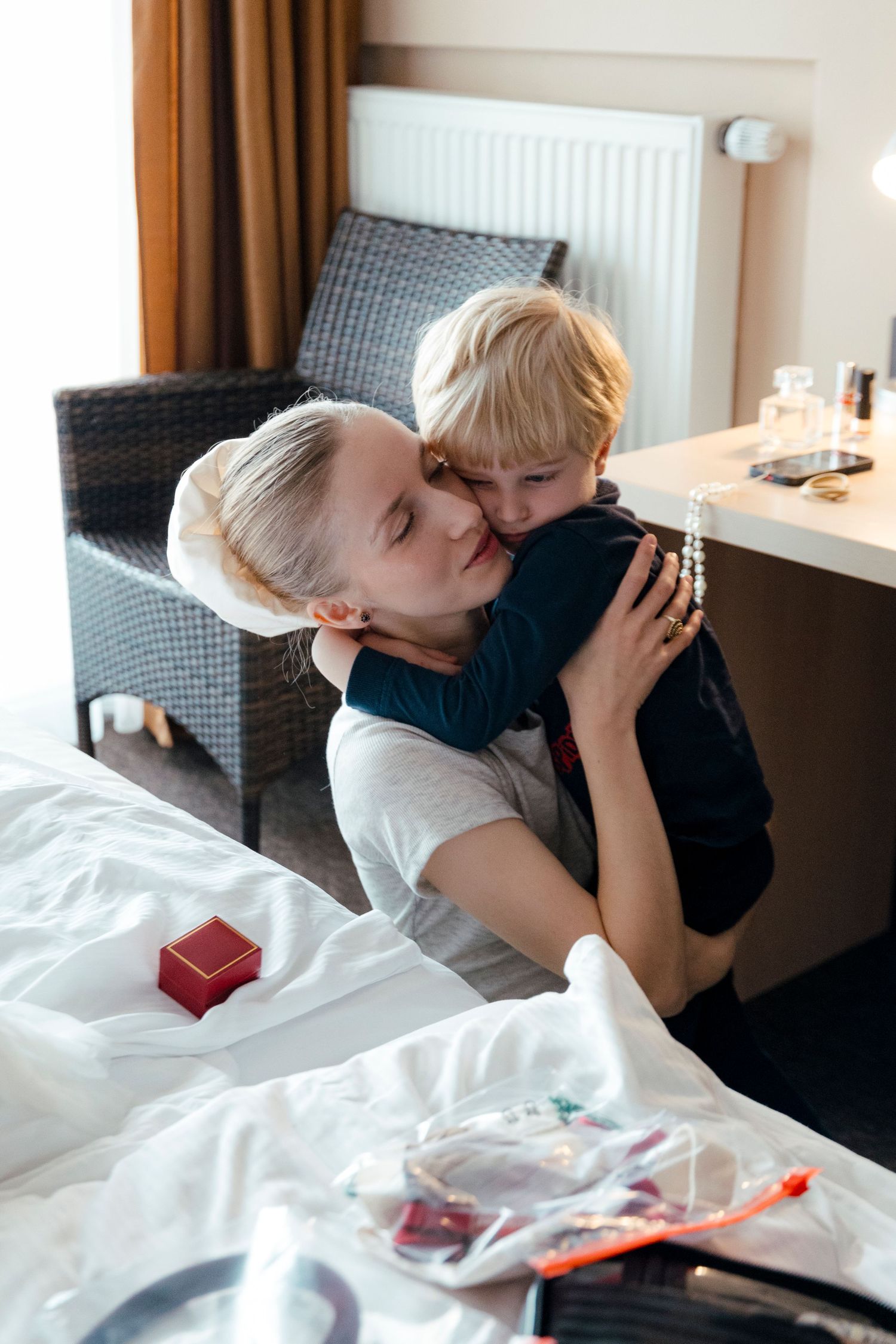 Intimate moment shared between two people on white bedding.