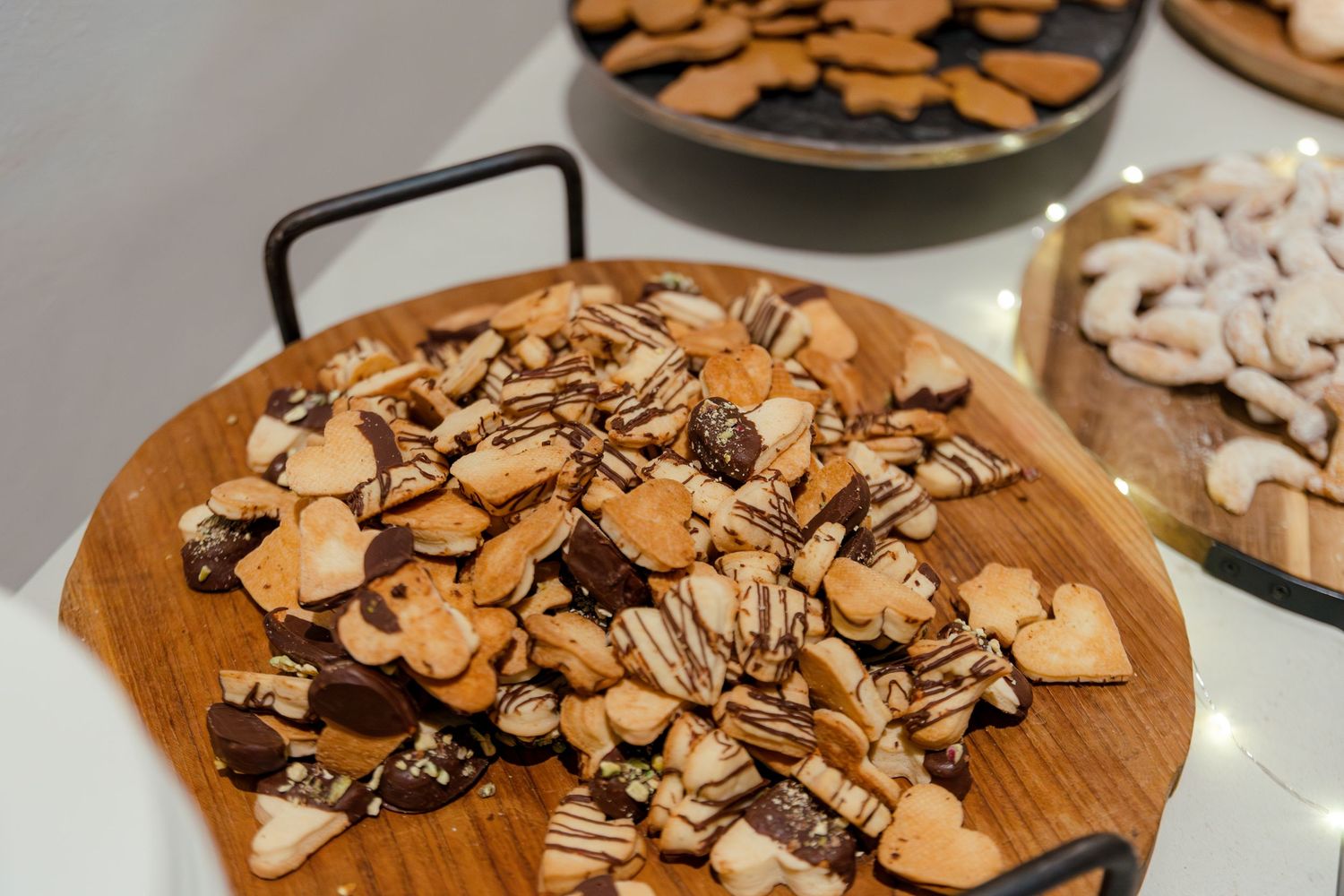 Chopped almonds and nuts arranged on wooden serving boards at a wedding reception.
